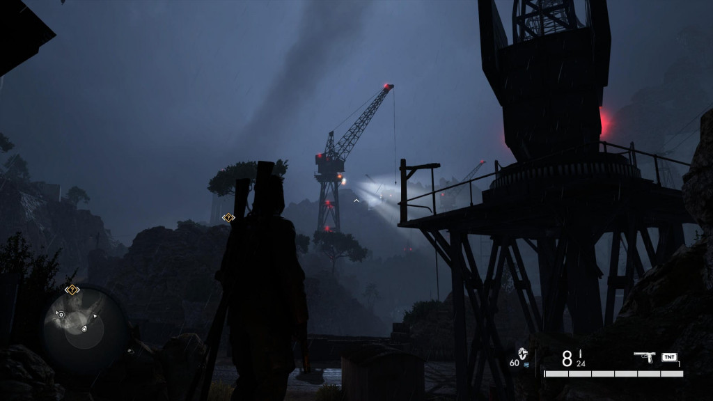 the camera is behind the character. he is shrouded in darkness with a crane visible in the background illuminated by the mix of moonlight and spotlights