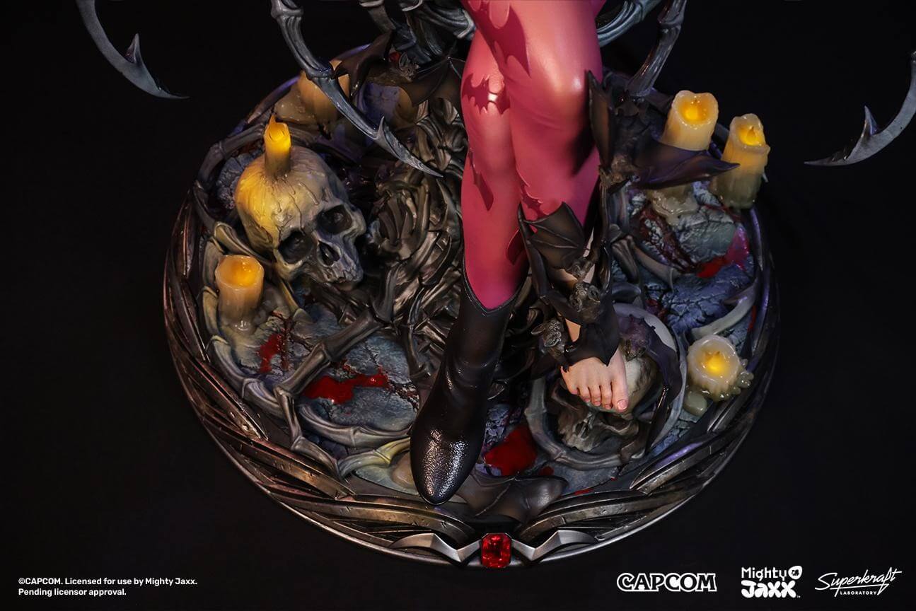 A detailed figurine featuring a character with bat motifs, surrounded by skulls and candles on a dark, atmospheric base.