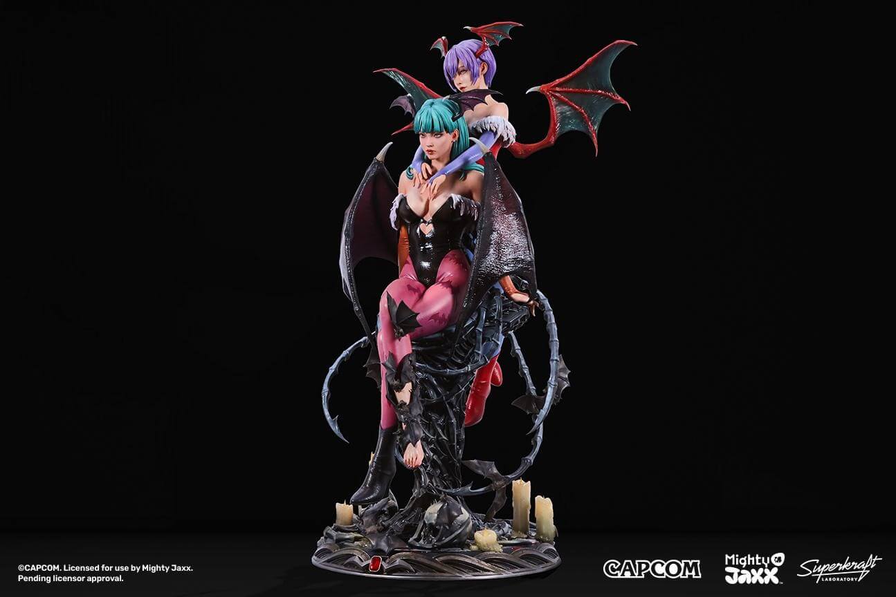 official image for the Mighty Jaxx Superkraft Morrigan statuette.A detailed figurine featuring two demon-like characters with wings, adorned in striking attire, surrounded by dark, eerie elements and candles.
