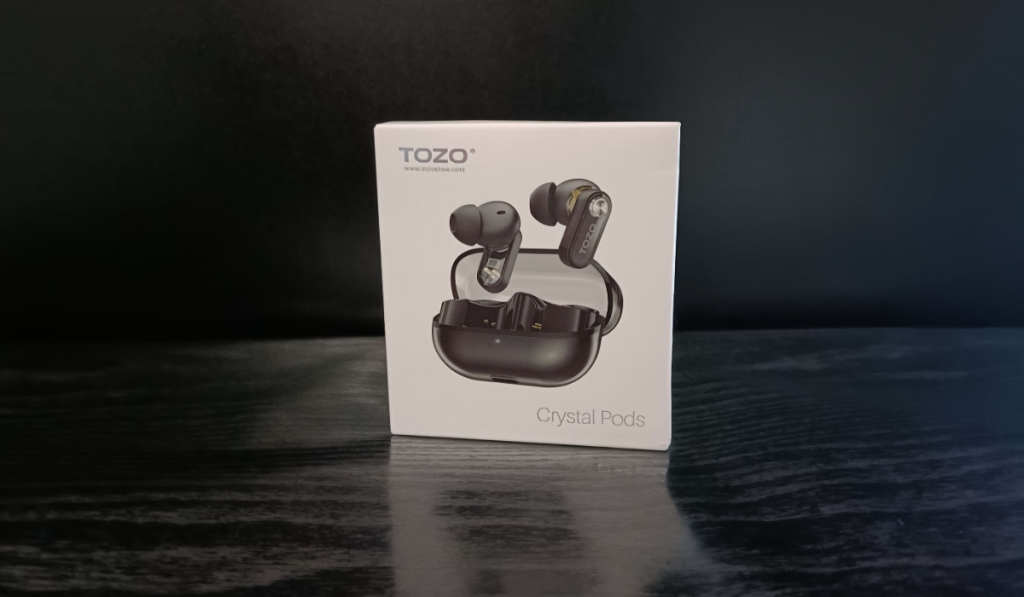 The TOZO Crystal Pods box sitting on a black surface with a black background