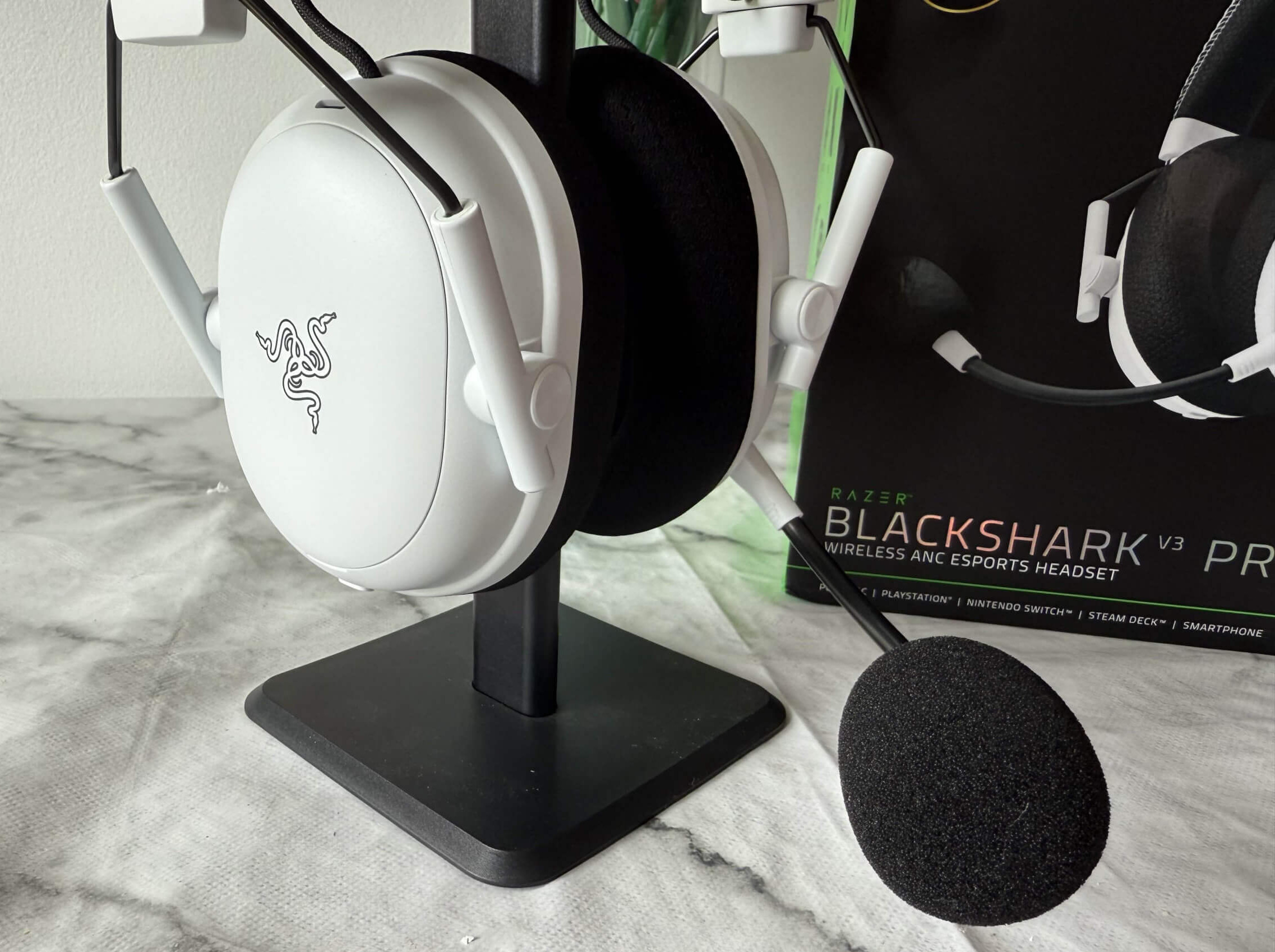 image of the blackshark v3 pro headset on a stand whoing off the microphone and the front view of the headset