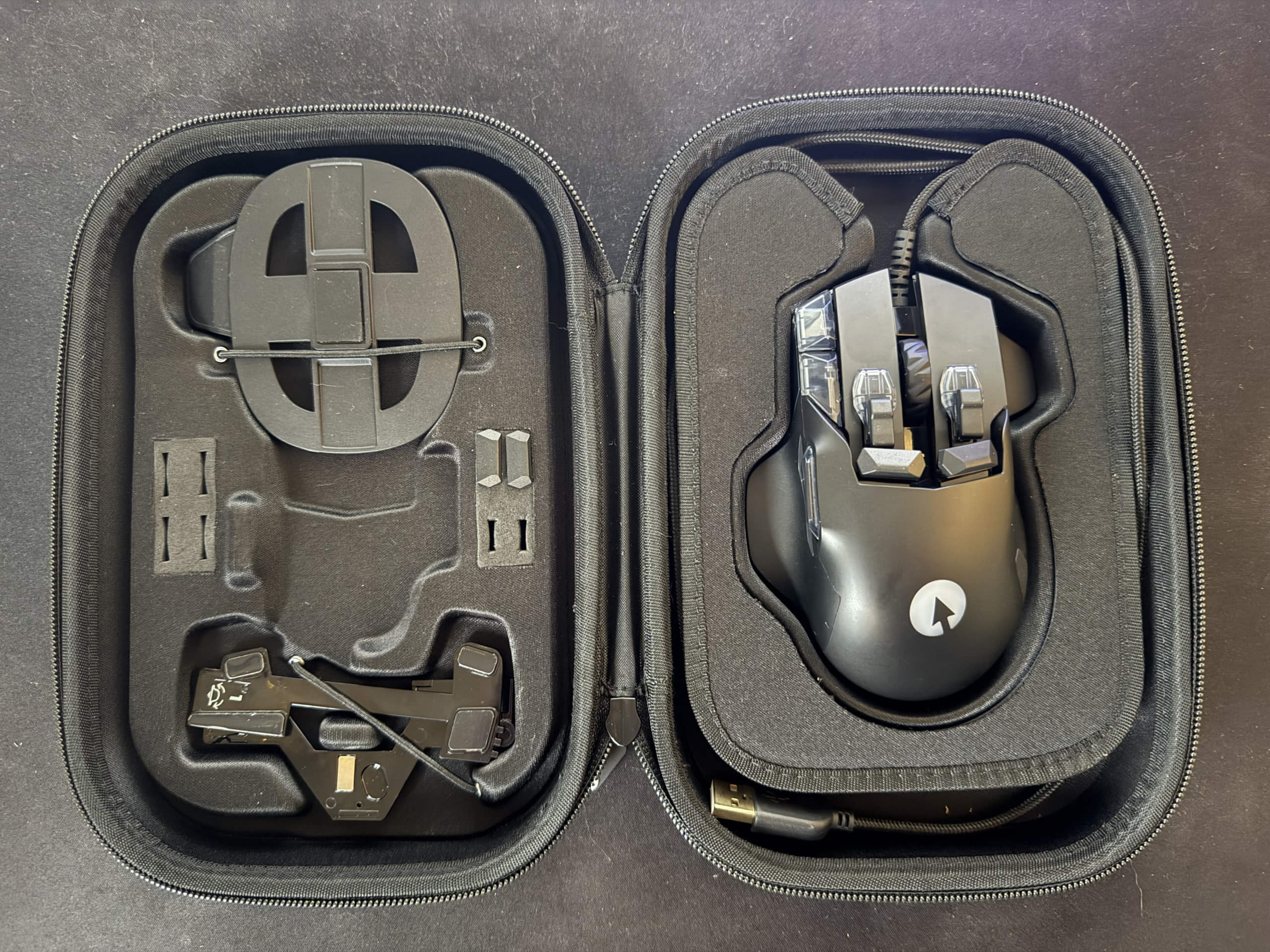 The swiftpoint Z2 gaming mouse sitting snuggly within its hard case. The otherside of the case has all of the customisable parts securely strapped into place.