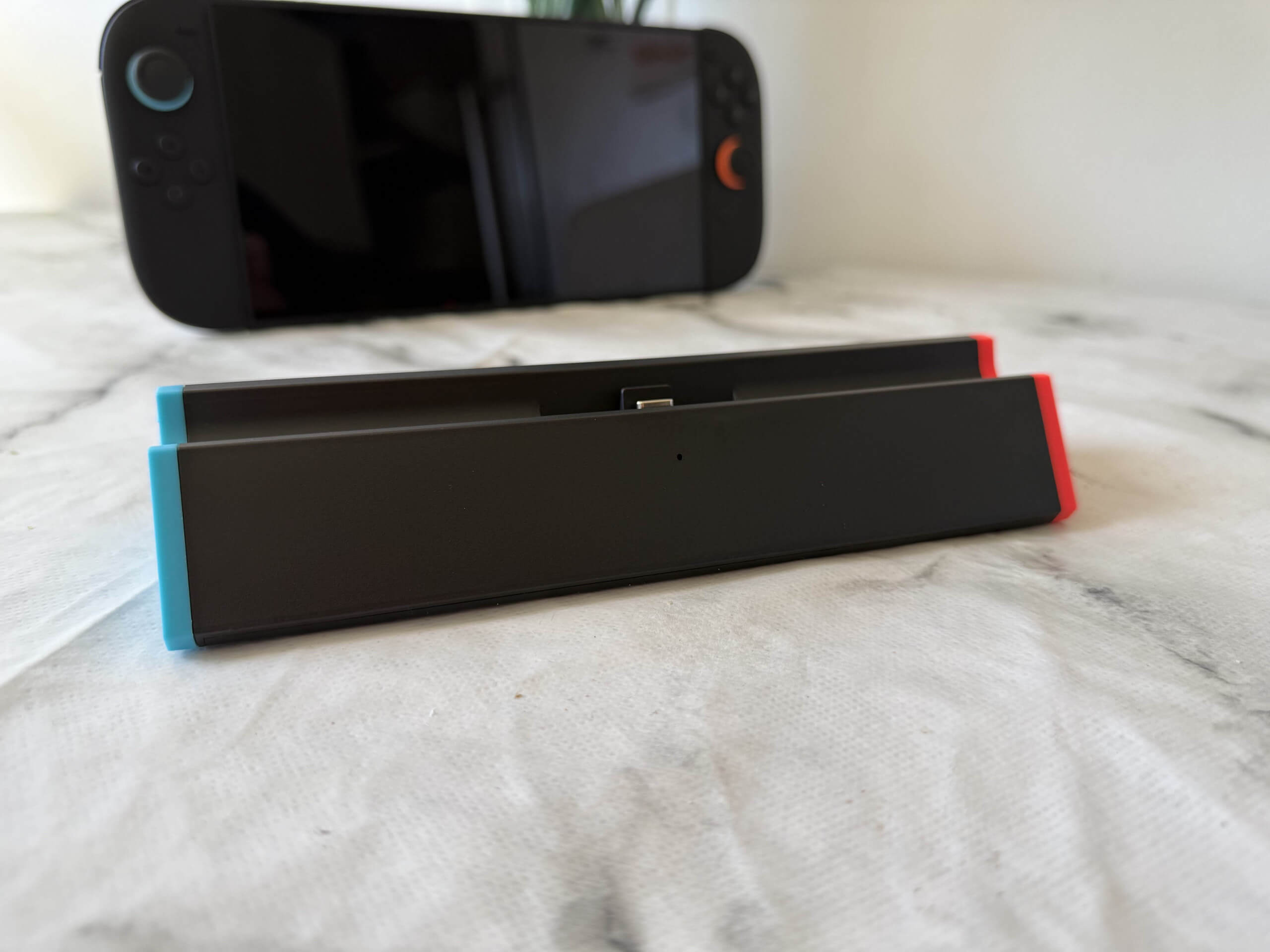 switch 2 dock in front of a switch 2 console on a table