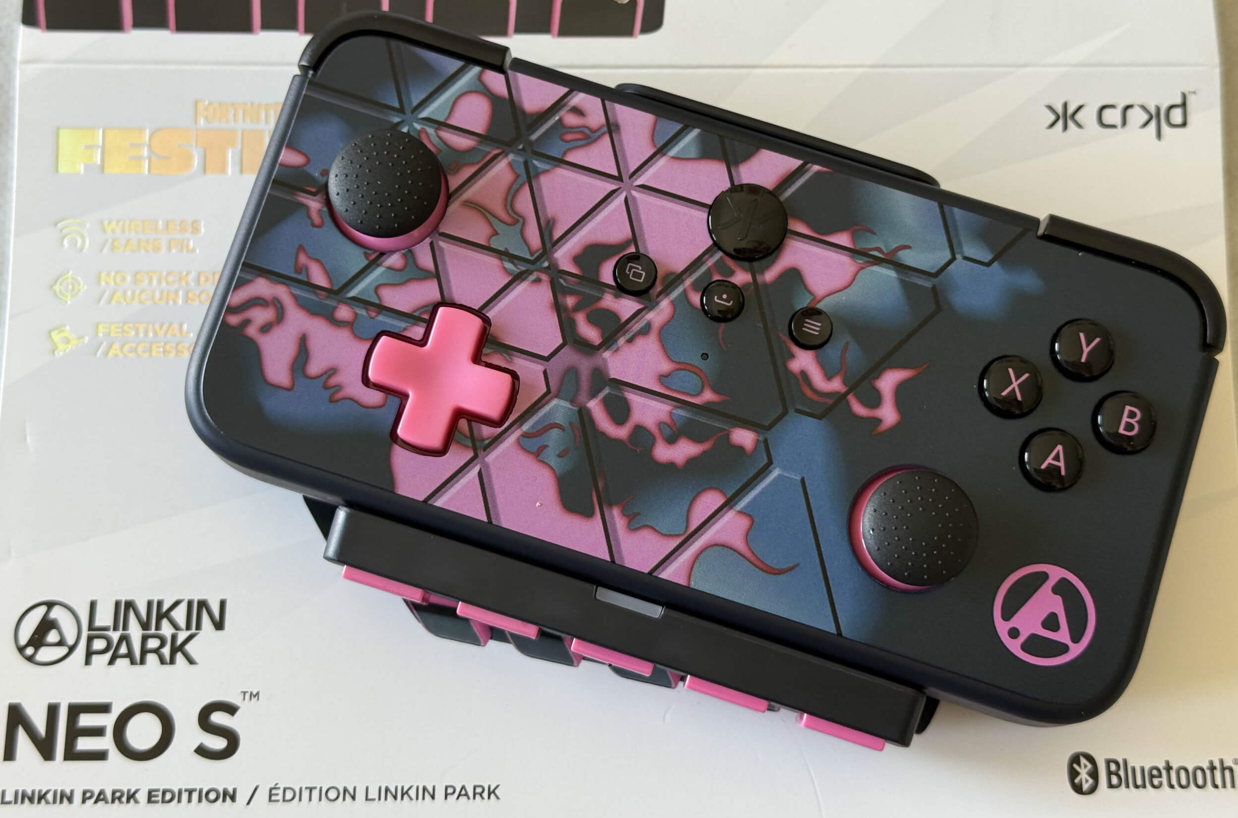 Colorful Linkin Park NEO S wireless game controller featuring vibrant pink and blue design, displayed on a white box.