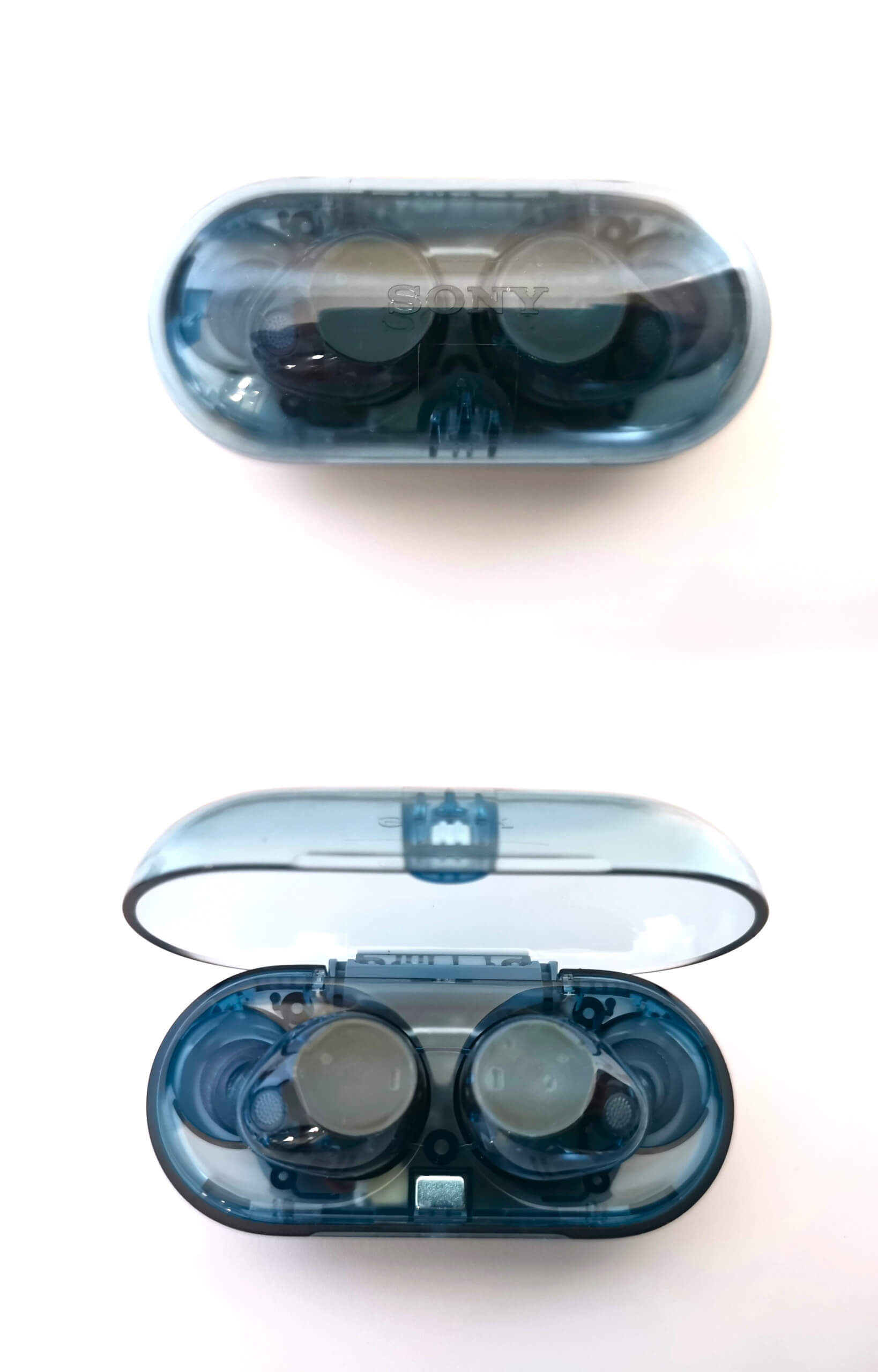 Transparent glass blue Sony WF-C710N pictured above in a closed case and below in an open case. All over a white background.