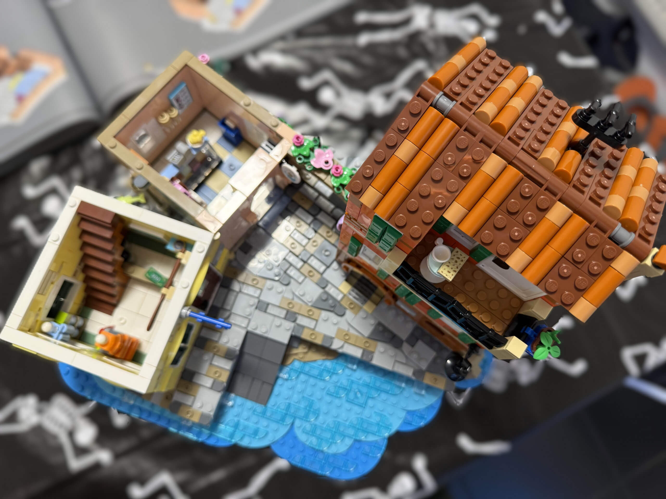 Top down view of first section of the LEGO Italian Riviera set. Showing 3 buildings foundations and the lego instruction box in the background