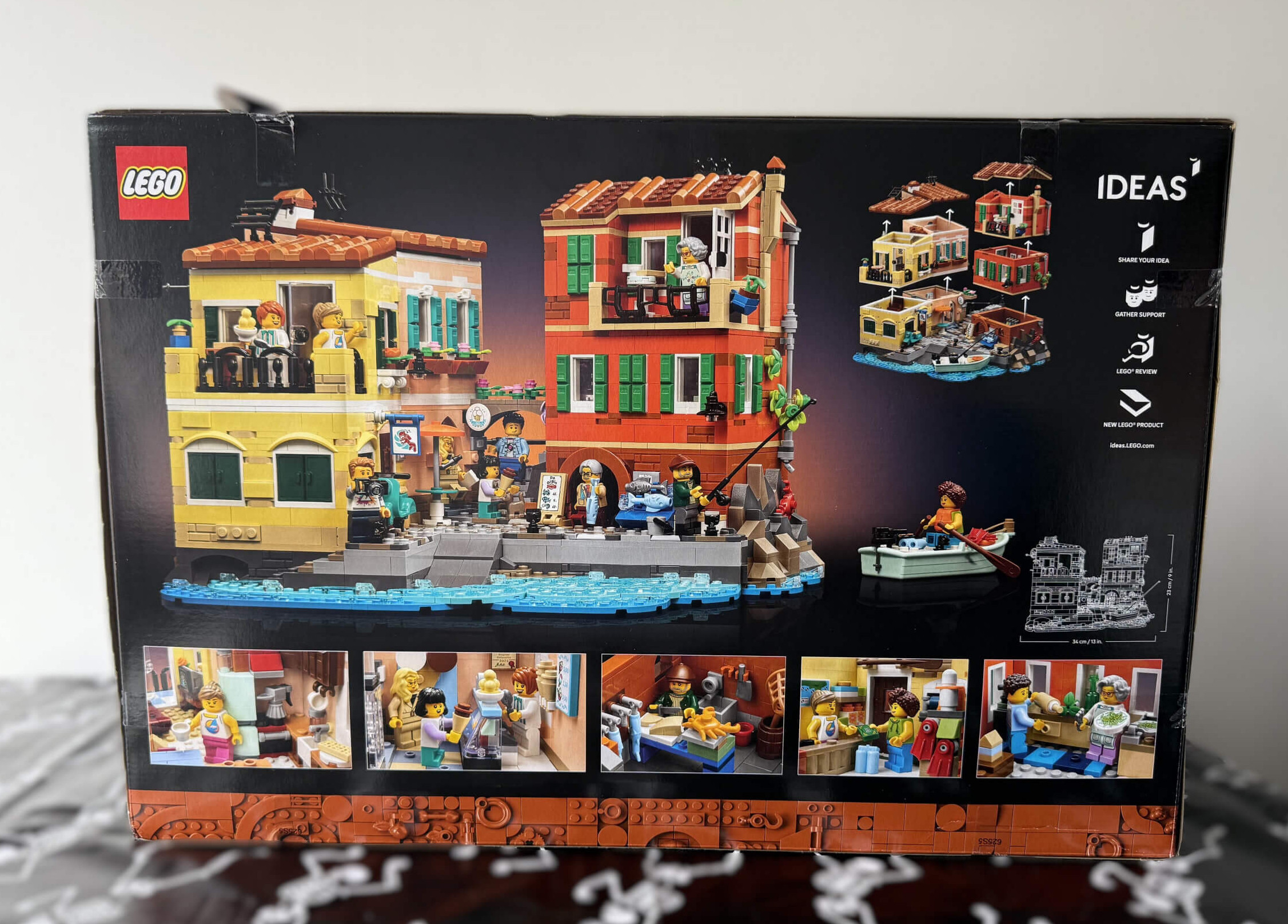 Back of the LEGO Italian Riviera box showcasing the vibrant Italian Riviera scene with colourful buildings, mini-figures, and a boat on the water.