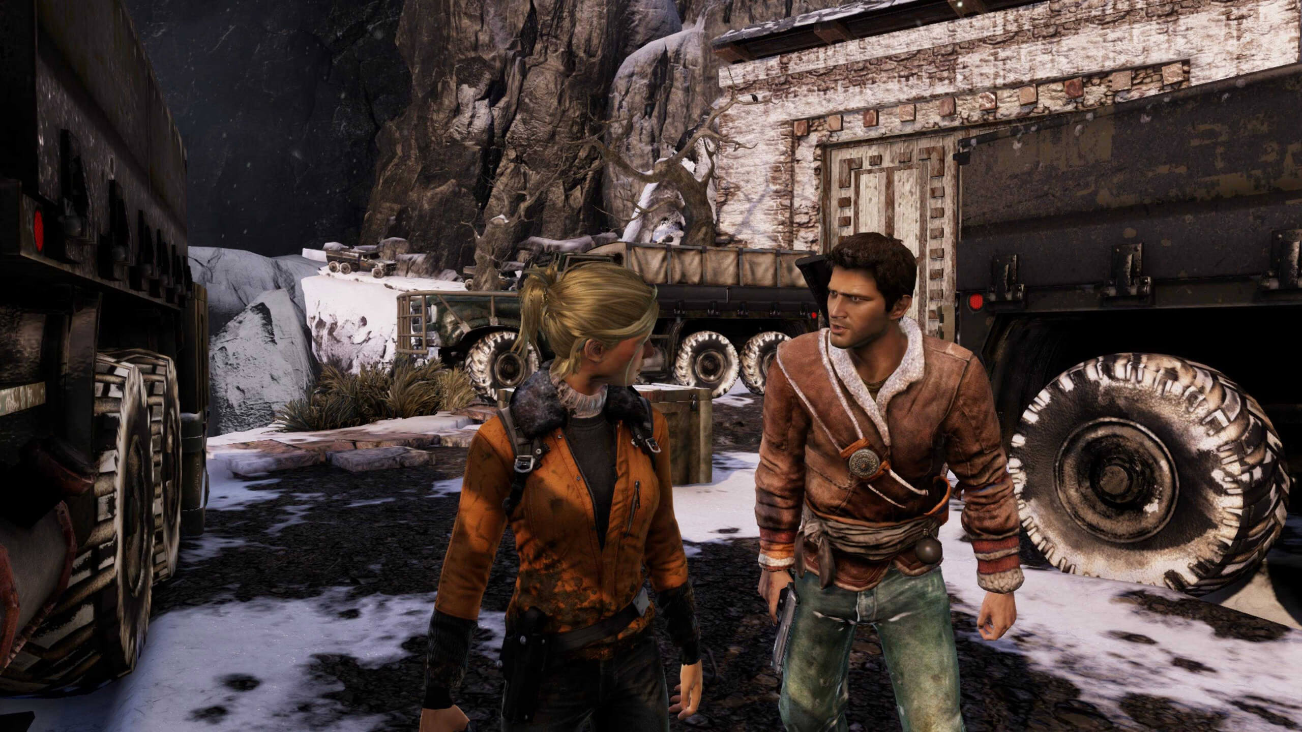 Screenshot from Uncharted 2: Among Thieves. 2 characters in conversation, stood among cargo trucks in a snowy, mountain location.