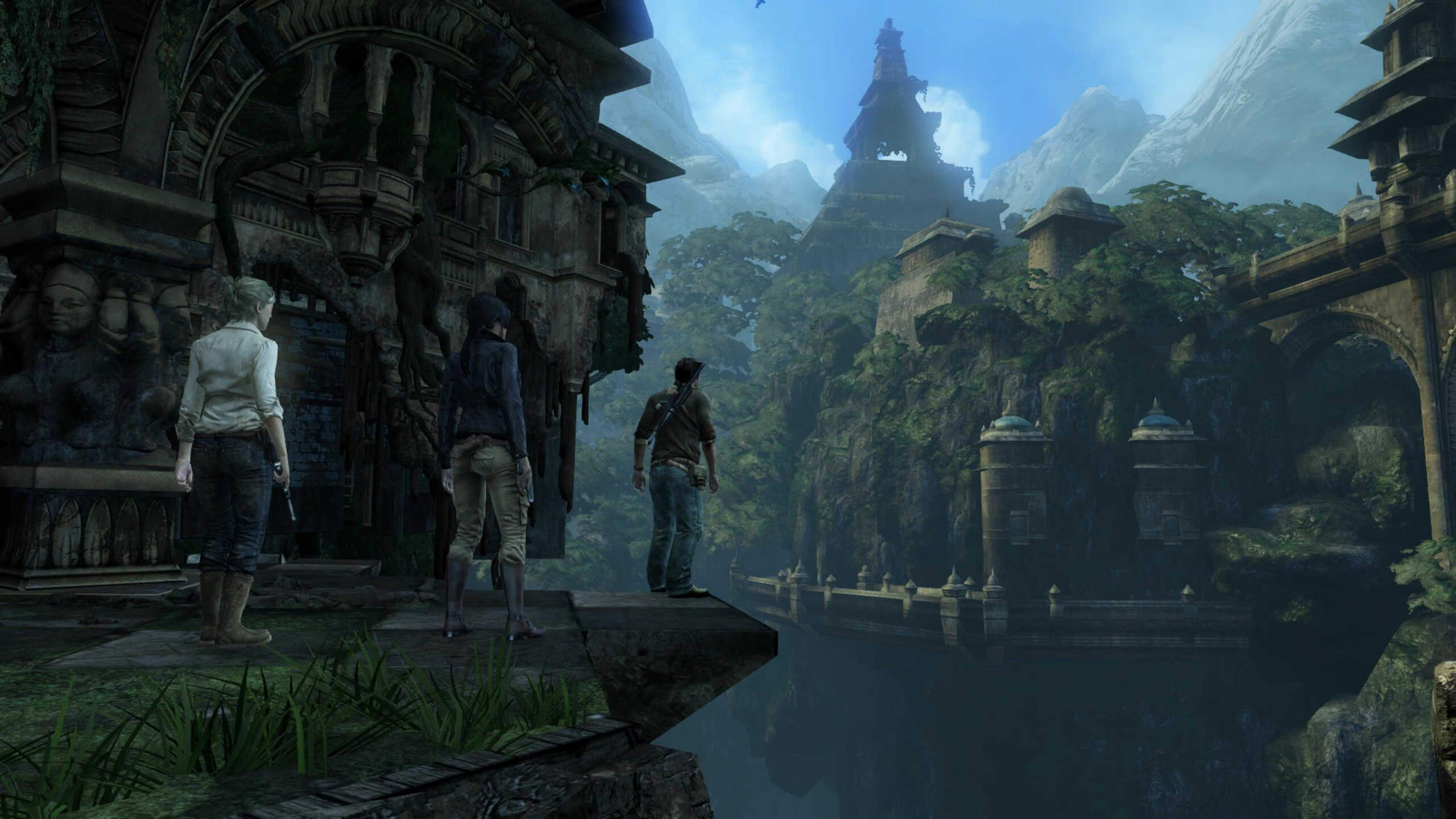 Screenshot from Uncharted 2: Among Thieves. 3 human characters stand among the ruins of an ancient temple, overgrown with plants, grass, and moss.