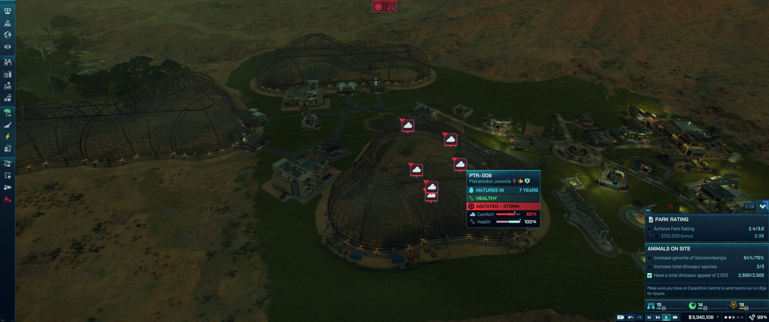 Aerial view of a dinosaur park with large enclosures, buildings, and an on-screen display showing a Pteranodon juvenile in a storm.