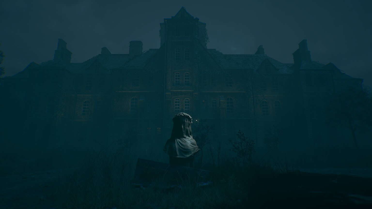 A large building heavily covered by fog. In front is a bust of a veiled lady. 