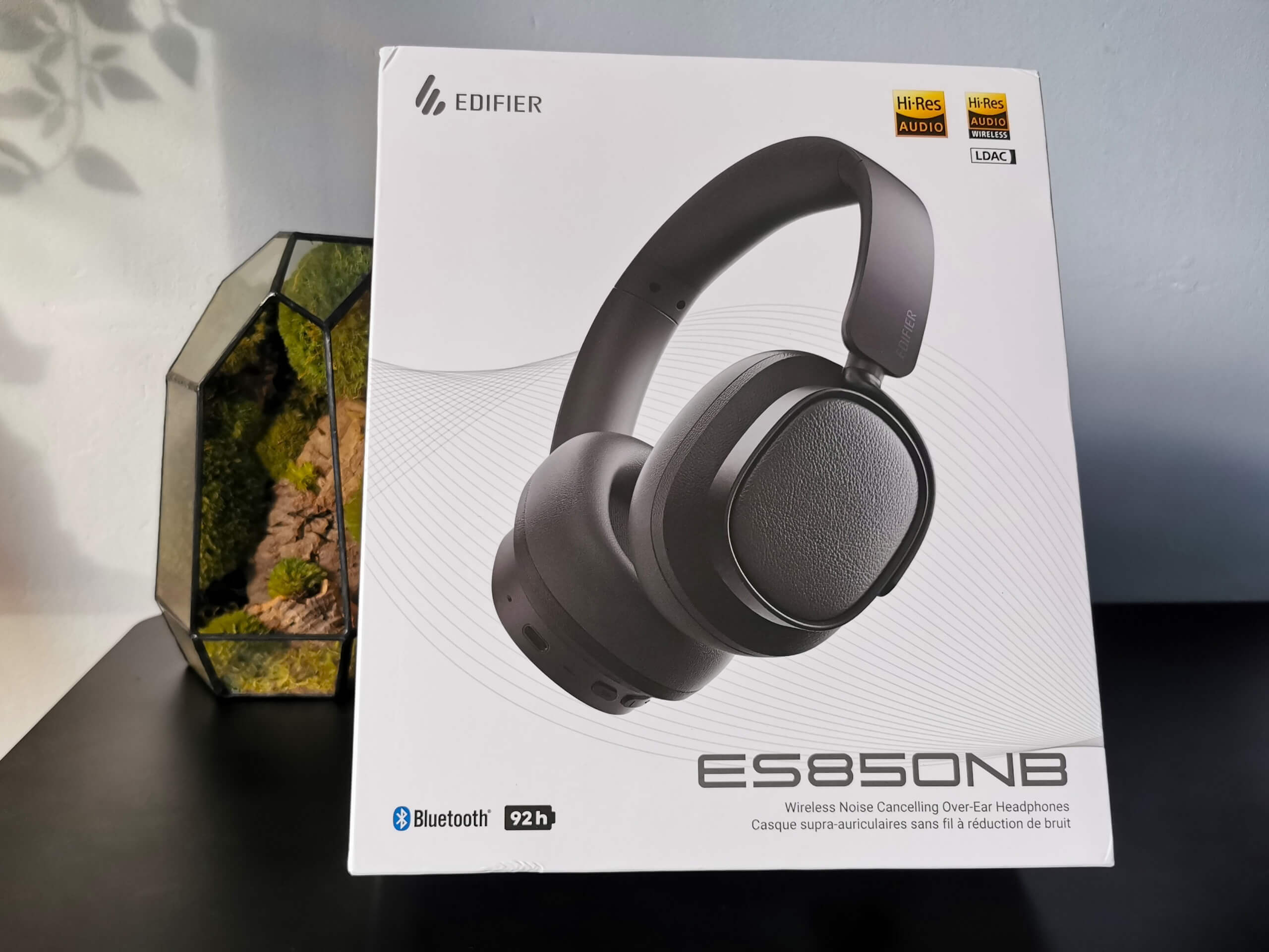 Edifier ES850NB pictured in their white box on a black desk