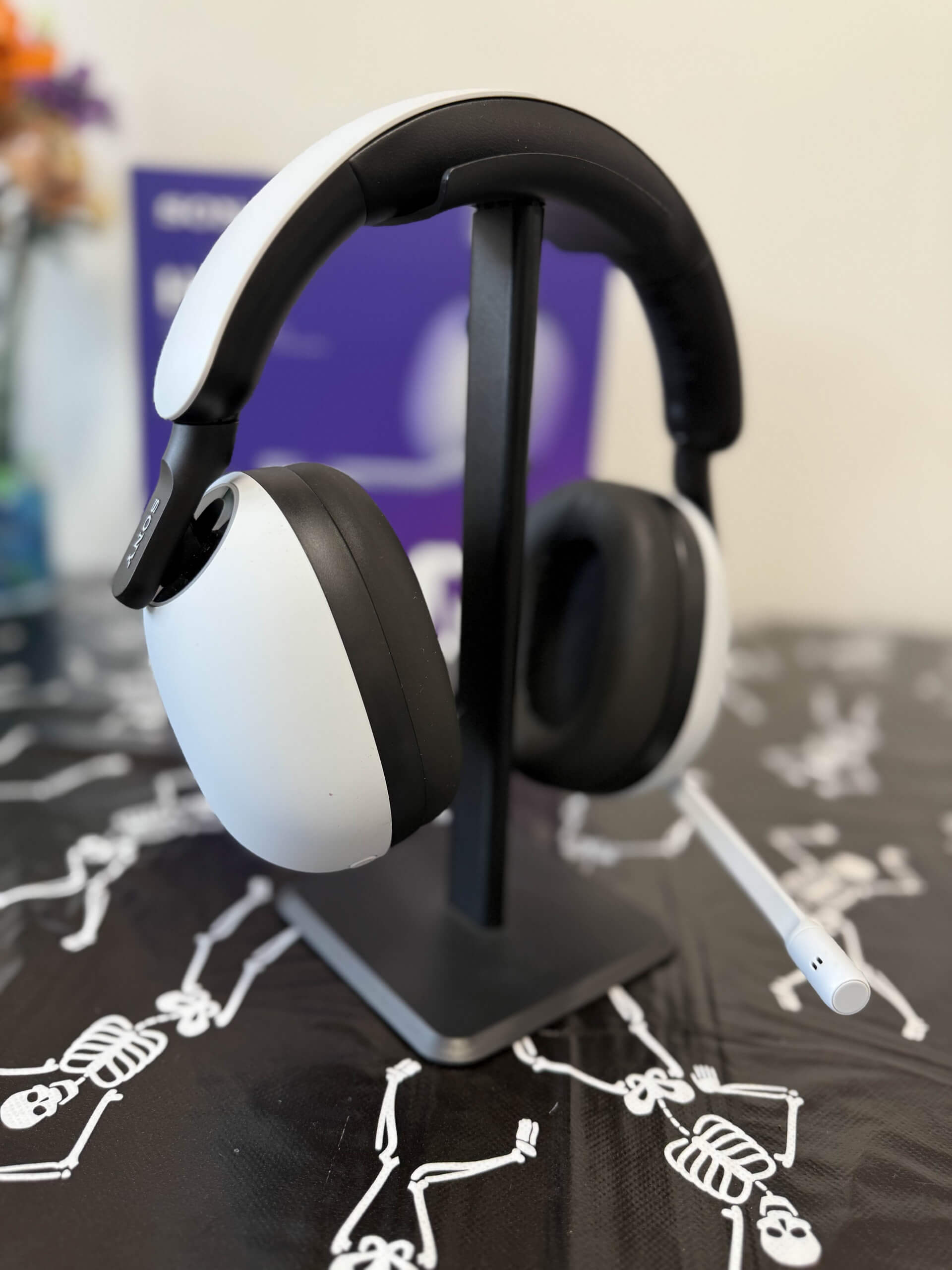 image of the inzone h9 headset on a stand on a table showing off the curves of the earcups