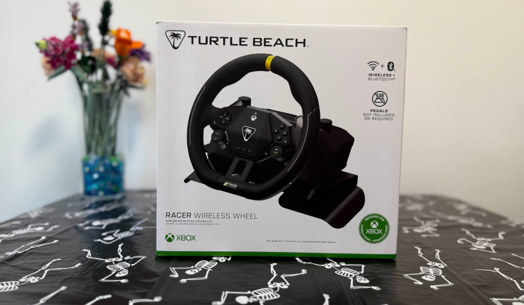 the turtle beach racer wireless wheel box on a table next to some flowers