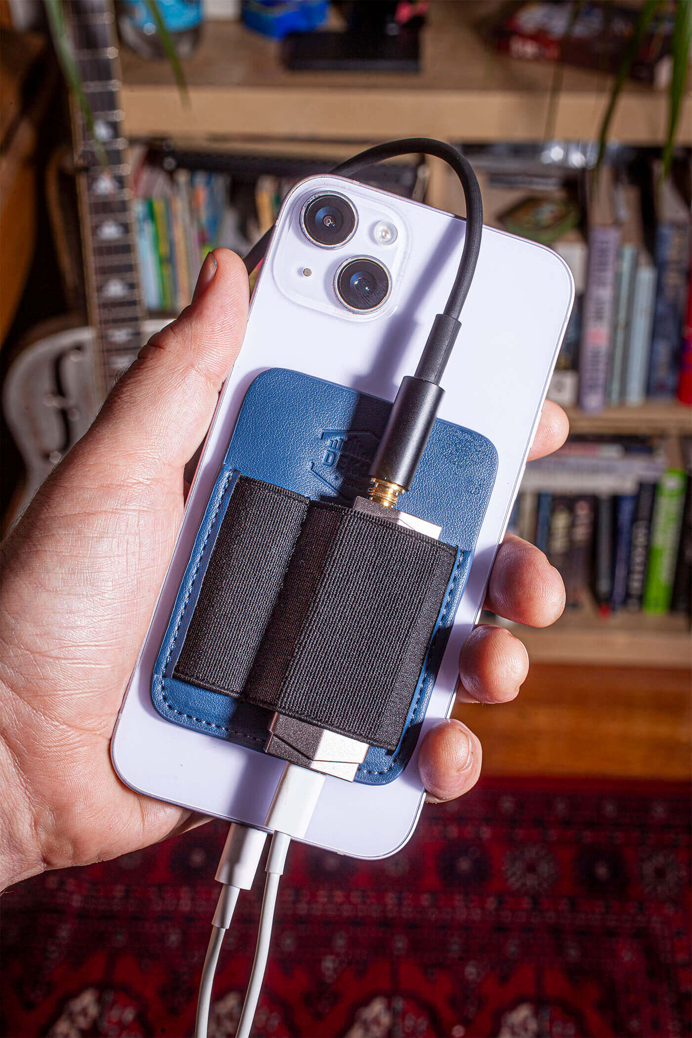 image showing a man holding the magdac attached with cables running off it