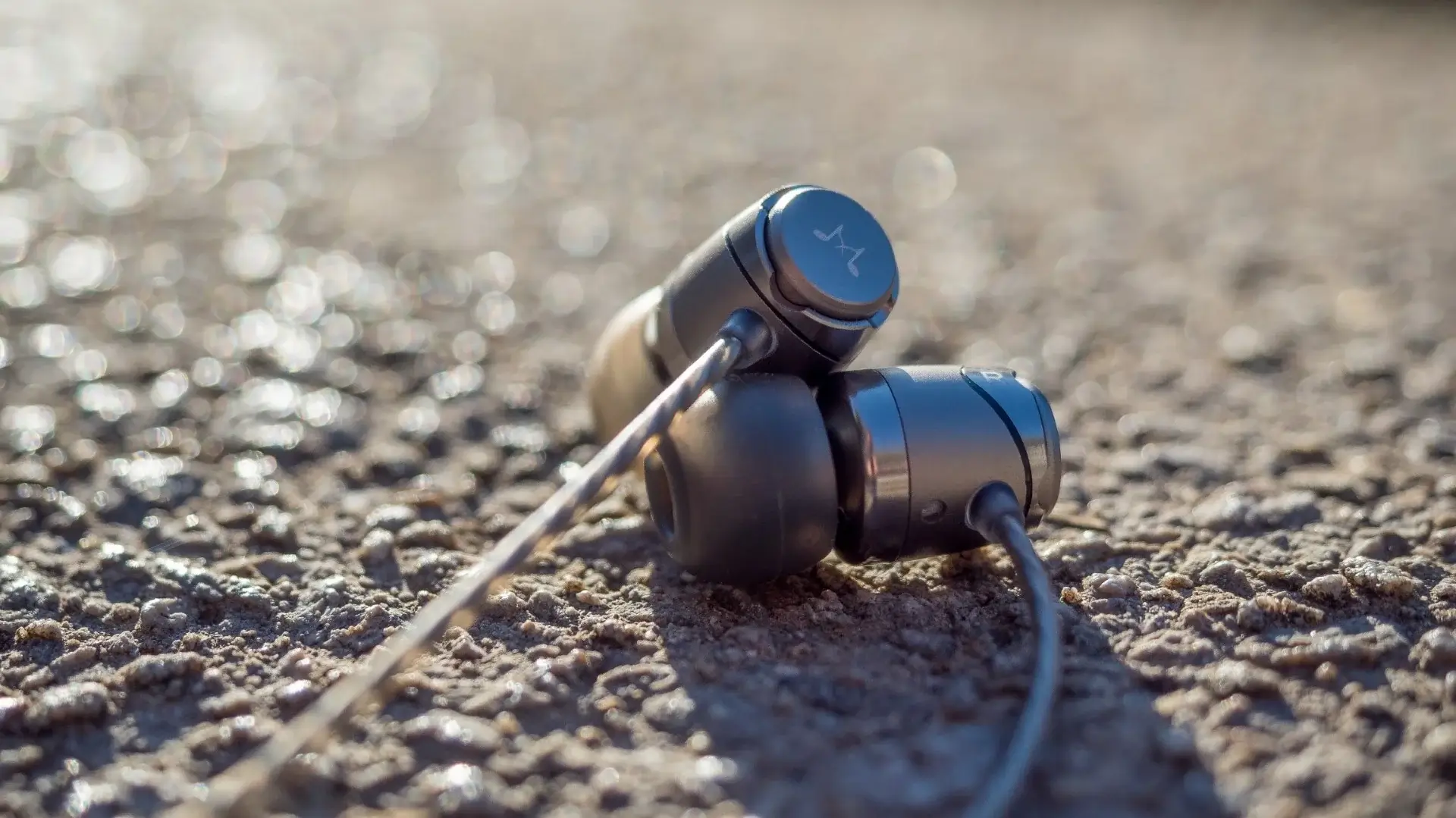 image of the E11C headphones on a beach