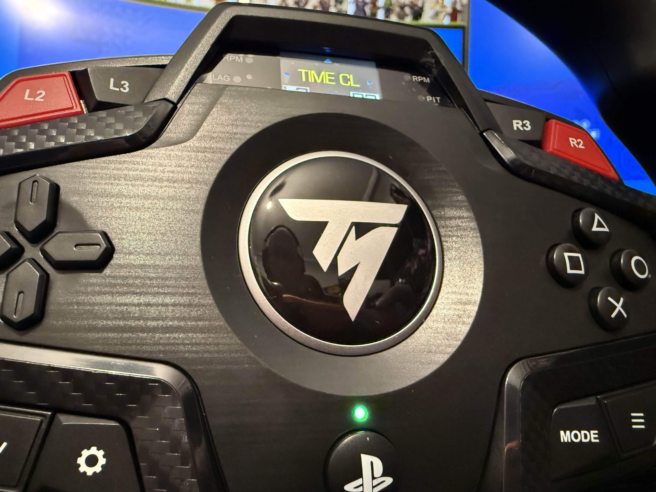 image of the thrustmaster logo close up with a reflection of me