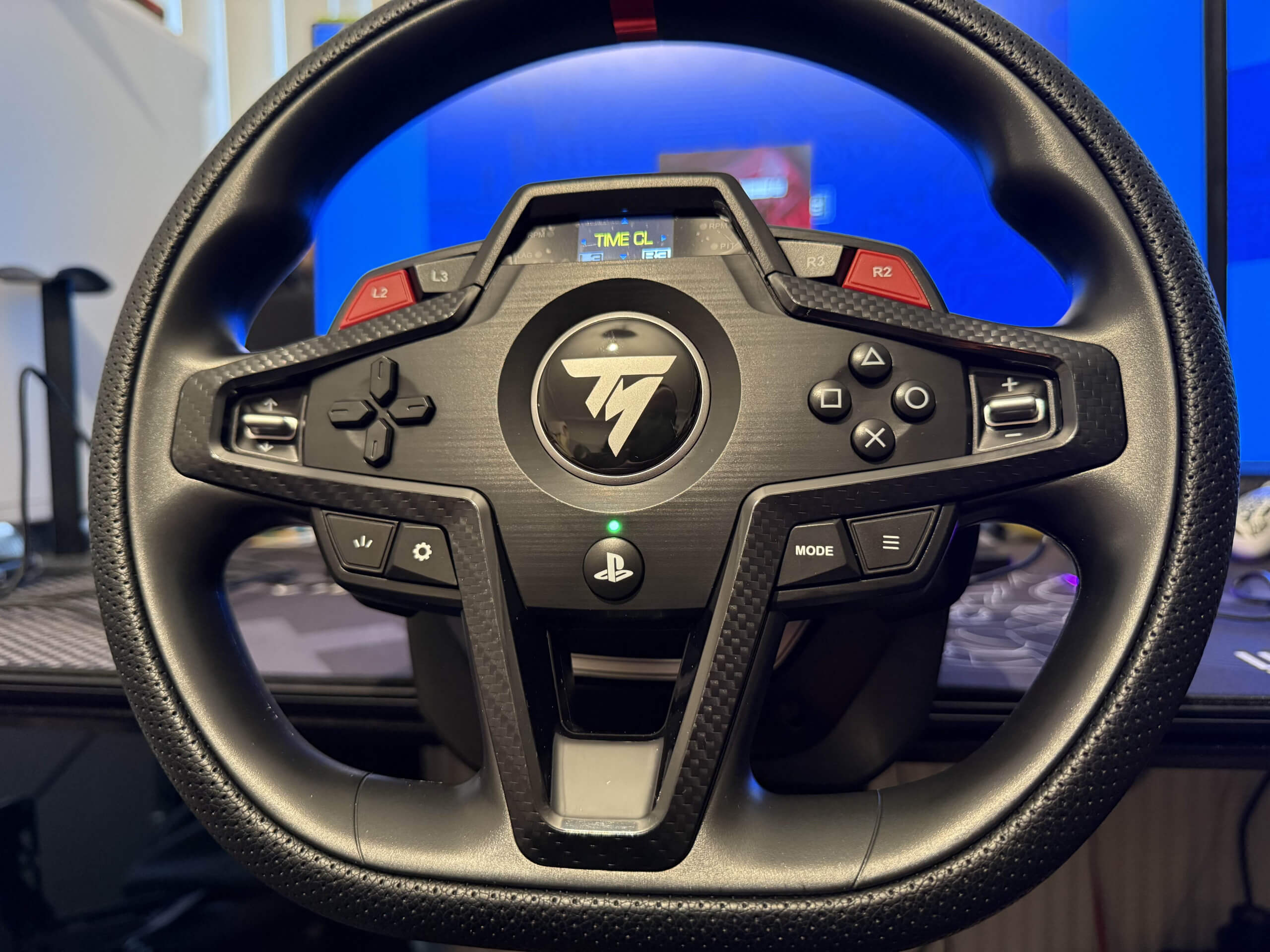 image of the thrustmaster t248r wheel featuring all the buttons as its connected to the desk