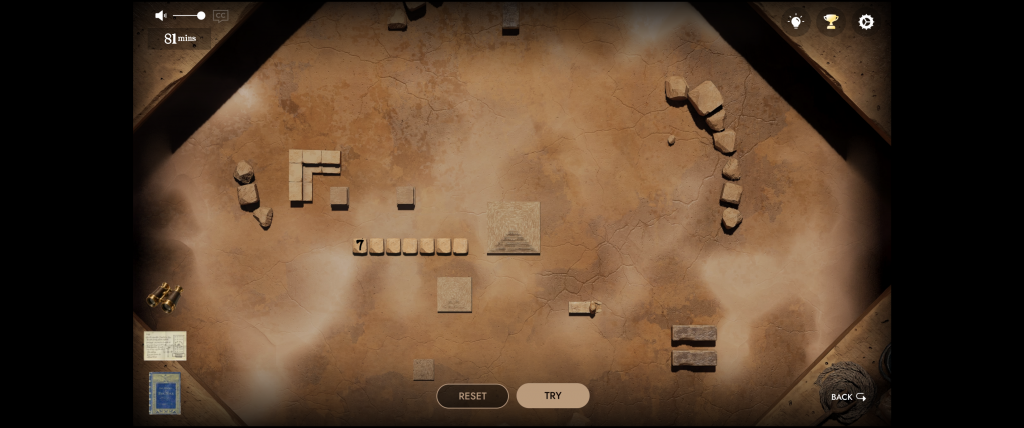 A sandy game board featuring assorted stone blocks, a small pyramid, and scattered rocks. Buttons below for "Reset" and "Try." Ancient-themed puzzle setting.