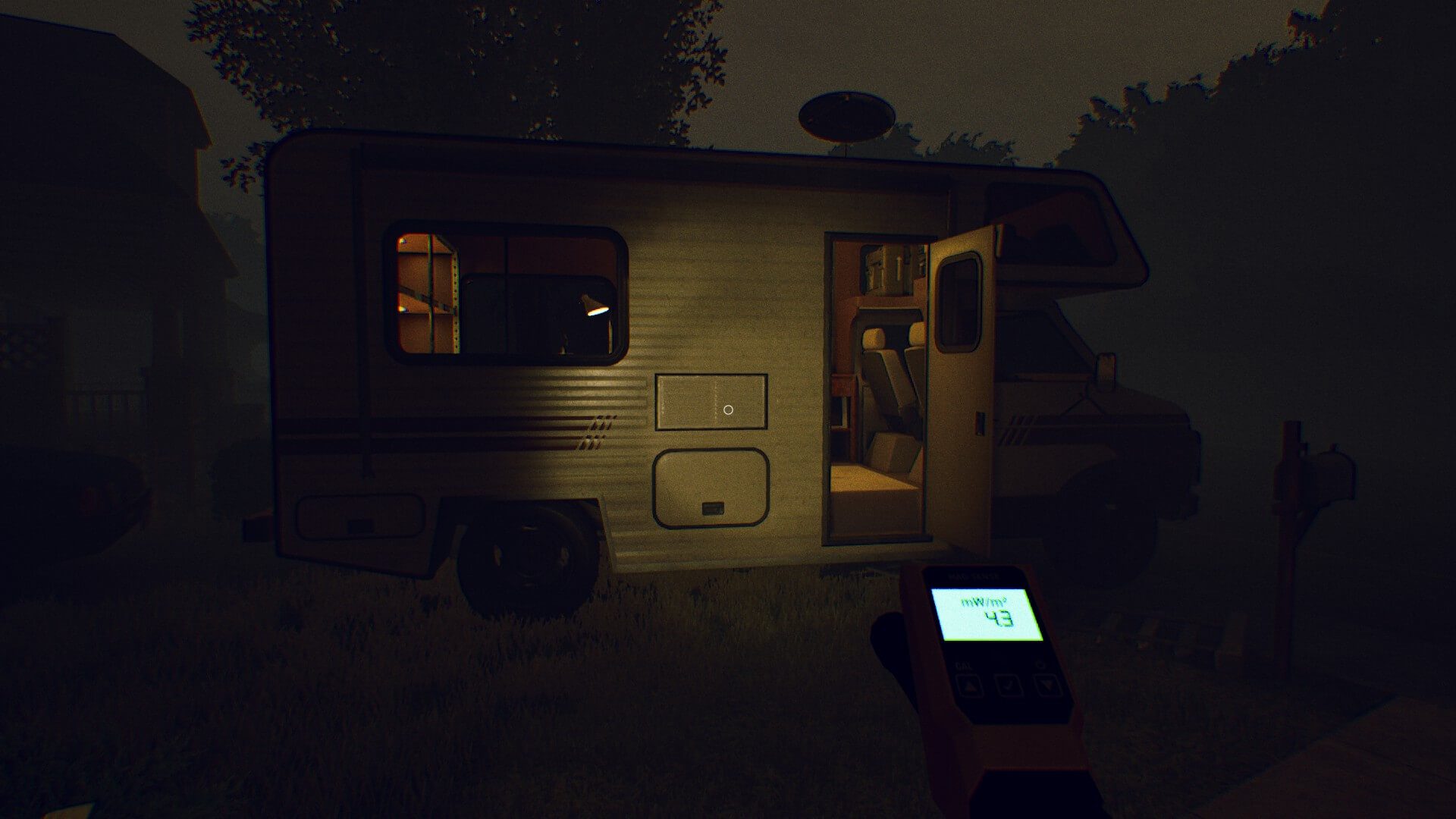 Torch shining on an open camper van. The light are on and two seats as well as a machine are visible on the inside.