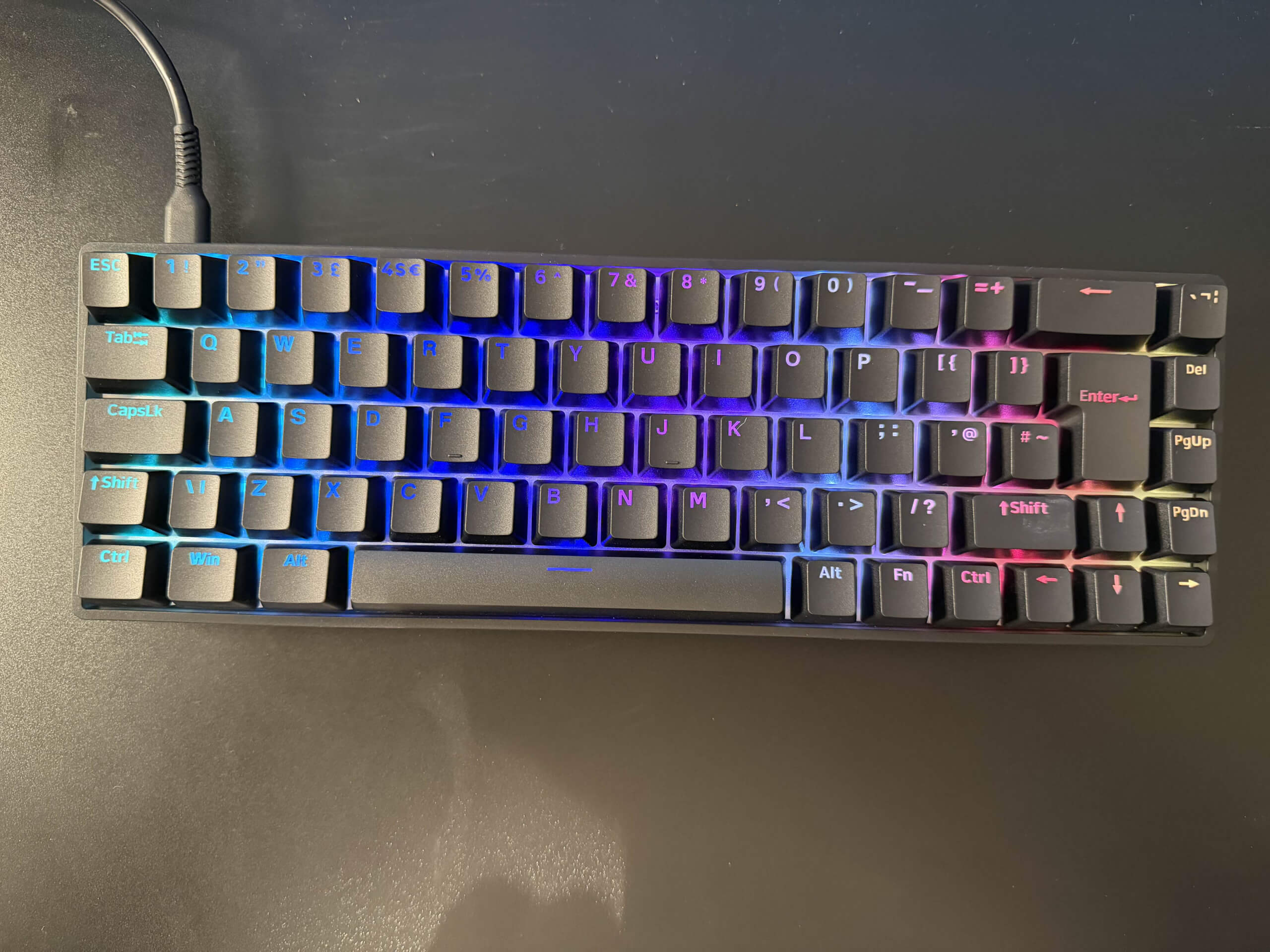 image of the flux 65 keyboard lit up on a black desk