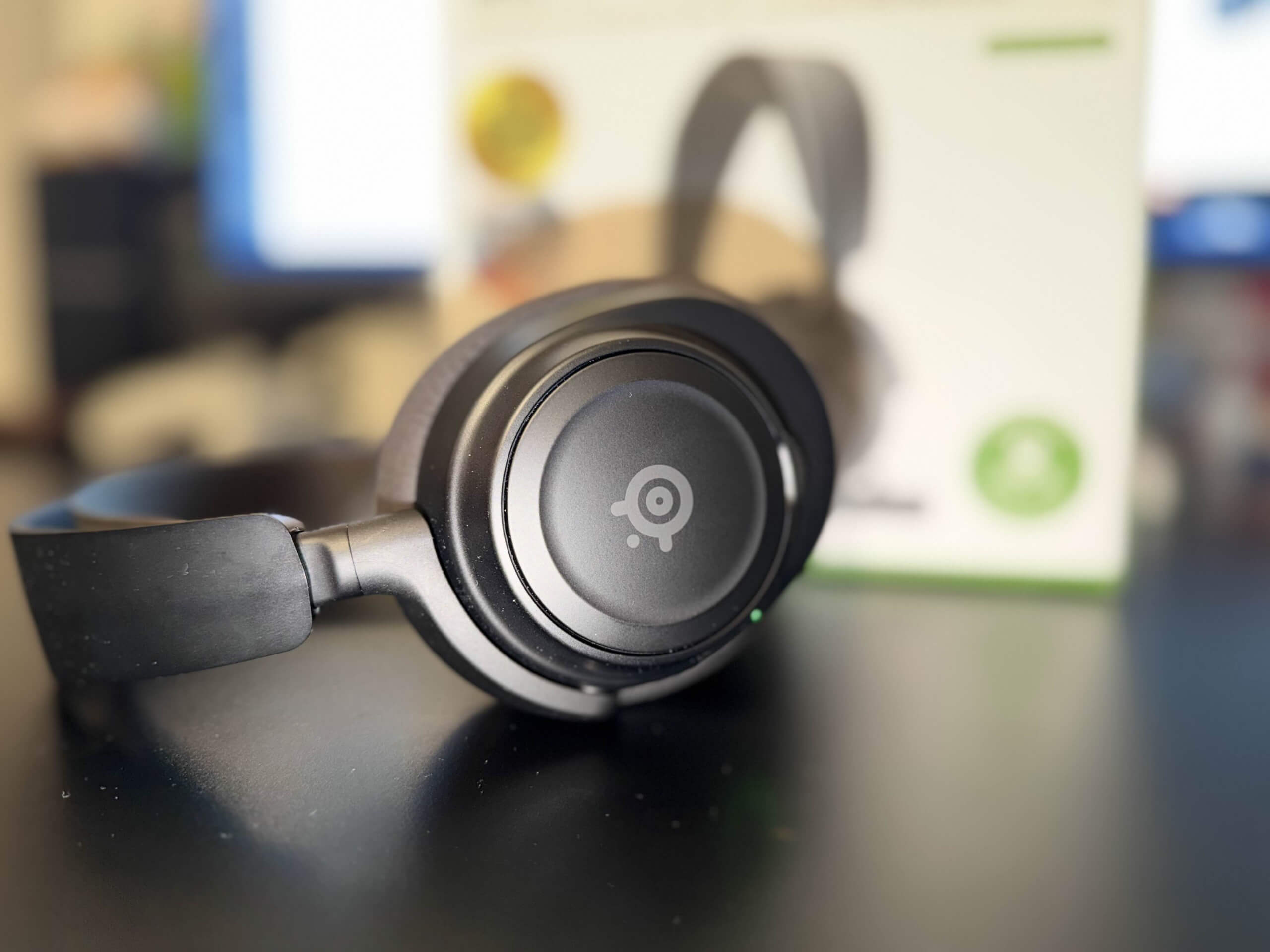 image 0of the nova 7x headset on its side in front of its box