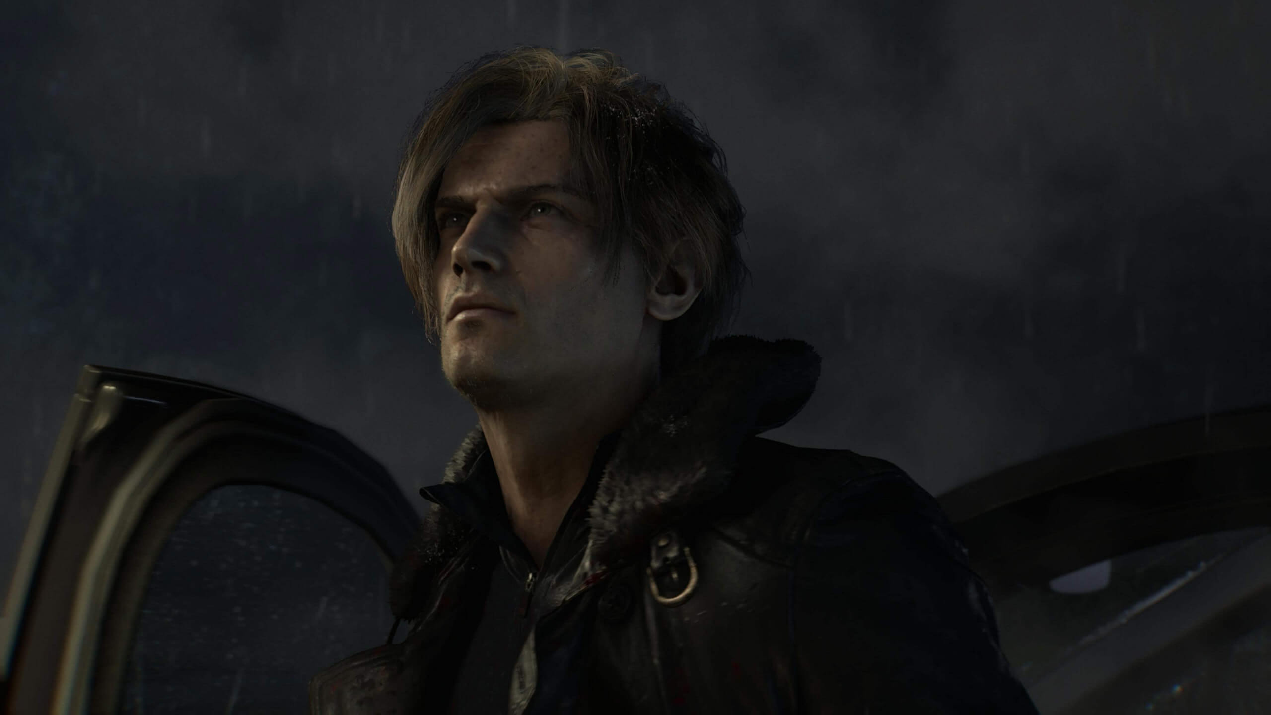 Leon Kennedy stands in the rain, the sky is dark behind him