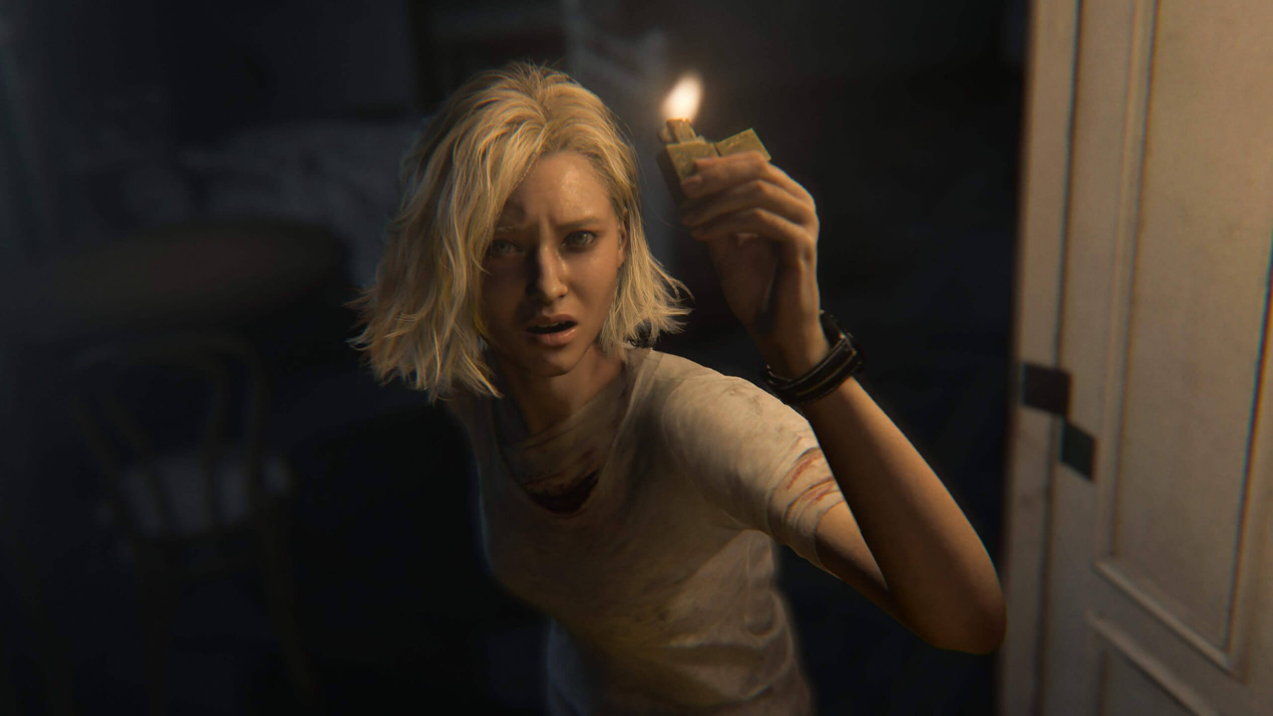 A woman with short blonde hair holds a match in a dark room, looking frightened and distressed.