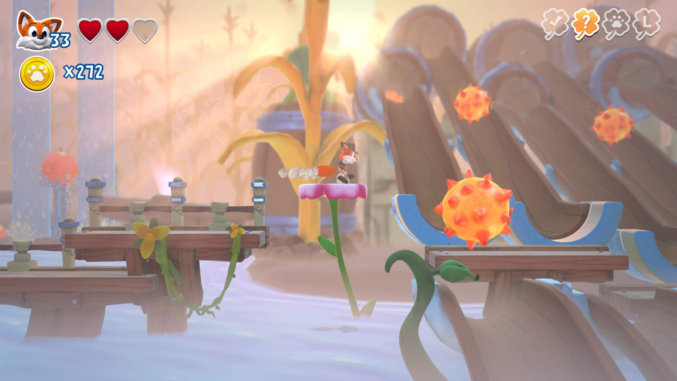 Lucky the fox jumps between two platforms where giant orange balls roll towards him