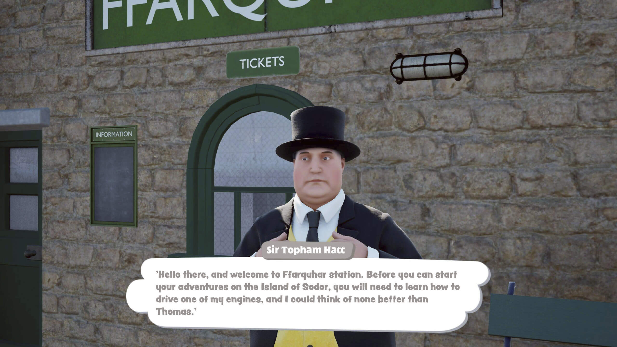 Sir Topham Hatt stands in front of a stone wall at Ffarquhar Station, wearing a black top hat and suit, delivering a welcoming message in a speech bubble.