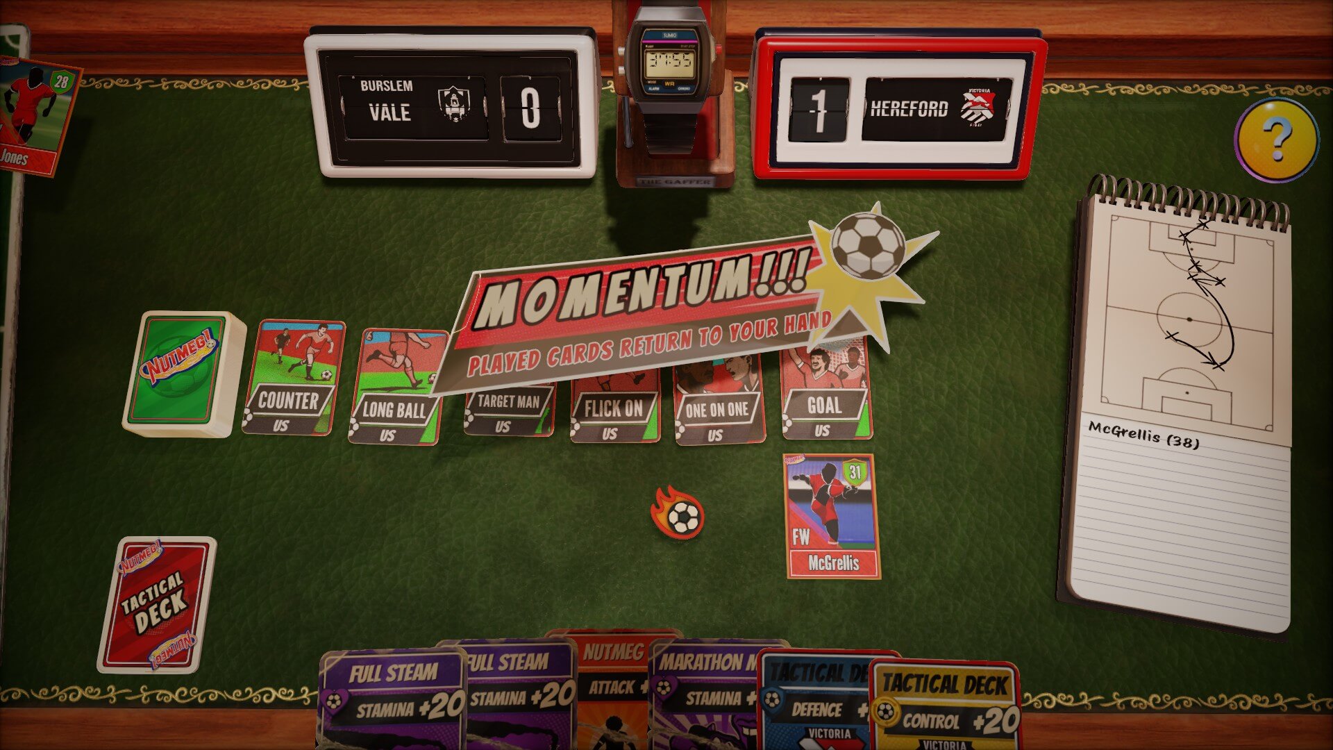 A card game setup on a green table displays football-themed cards labeled "Counter," "Long Ball," and more. The score shows Burslem Vale 0, Hereford 1. A notepad with strategy scribbles lies beside tactical decks and a retro watch.