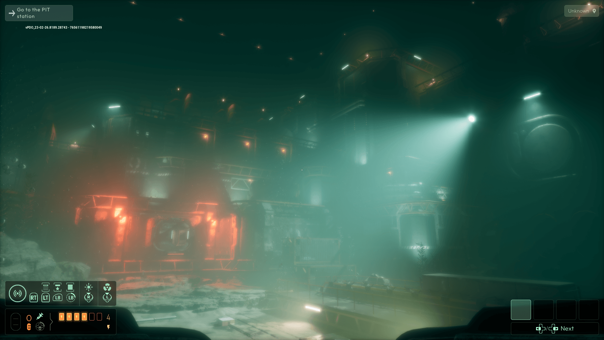 A large base under the sea, it is hard to see, but several lights aid in visibly. Two bright red lights highlight the entrance to the base. 