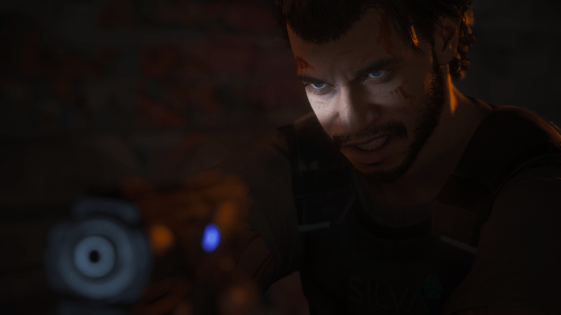 The character Jake Diaz is pointing his gun toward the screen. Some light is shining on a small area of his face. He is pulling a rather aggressive face. 