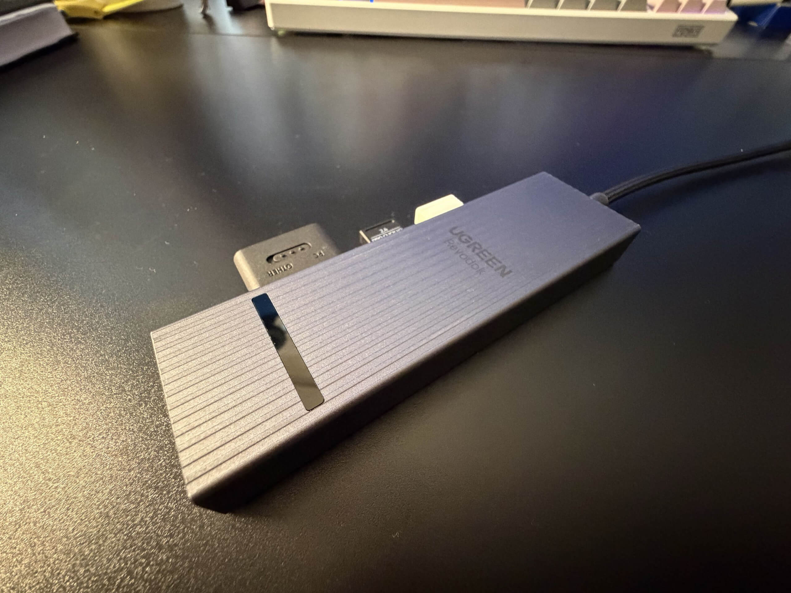 ugreen revodok on a desk with 3 usb dongles attached