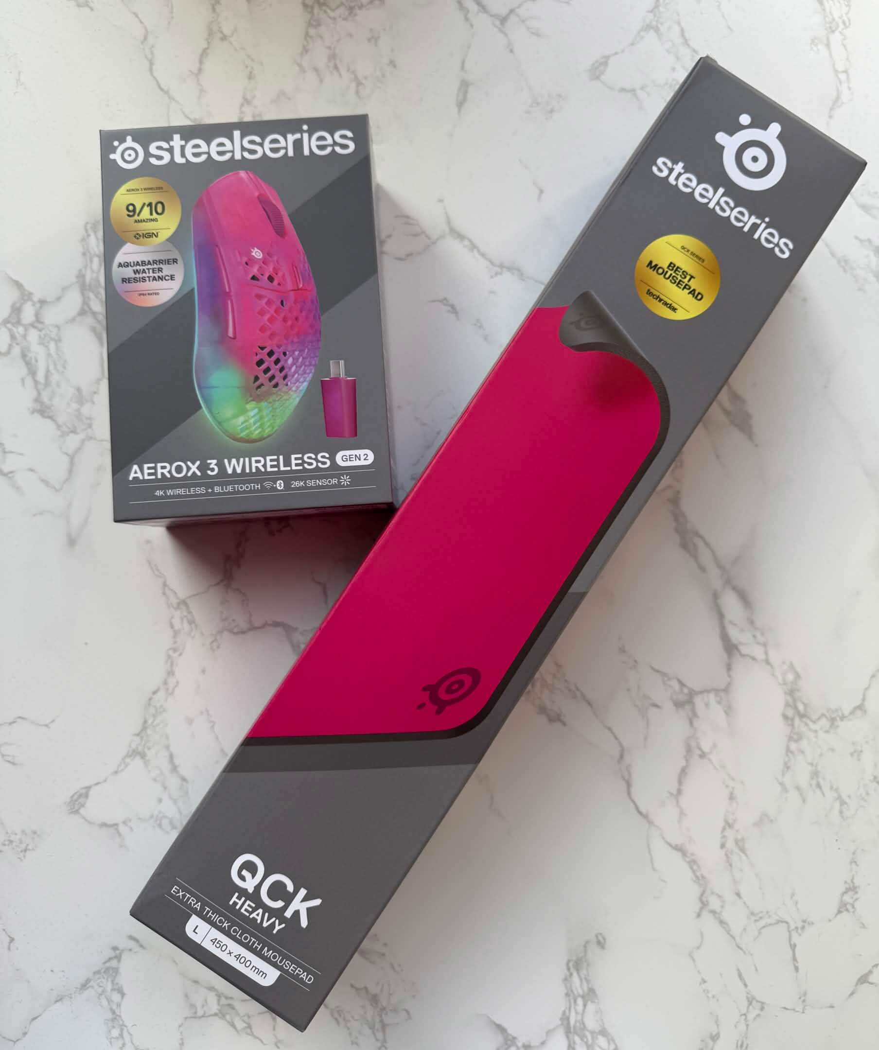 two boxes, the aerox 3 and qck heavy on a table