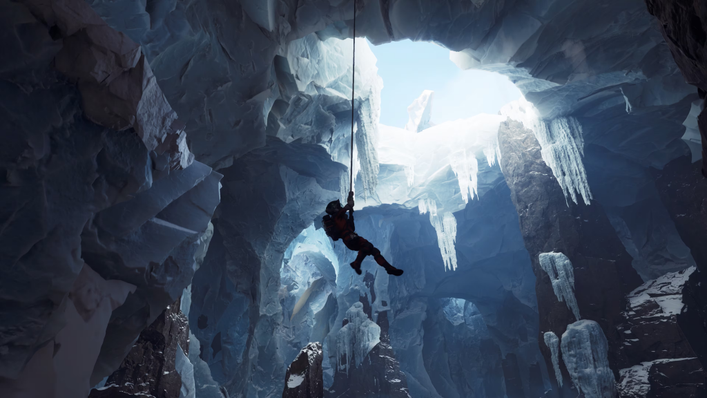 Ariane dangles from a rope in an frozen cave, surrounded by jagged icicles and icy walls. Though dim, sunlight breaks through the caves opening.