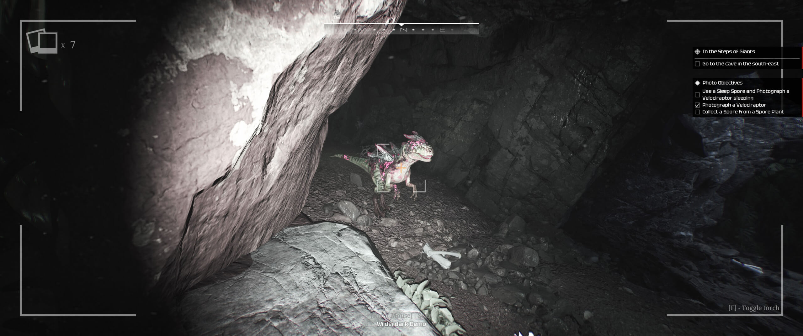 image showing a dinosaur in a tunnel lit up by a flashlight