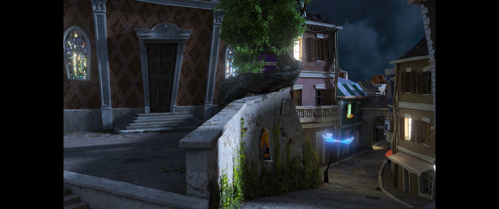 A dimly lit, cobblestone street curves past quaint, ivy-covered buildings under a starry sky. Warm light glows from windows, creating a cozy night scene.