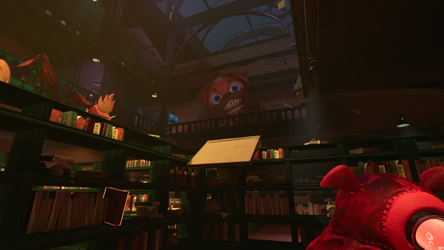 The player is in a library looking up to a large monster that's face is that of a dog with large blue eyes. 