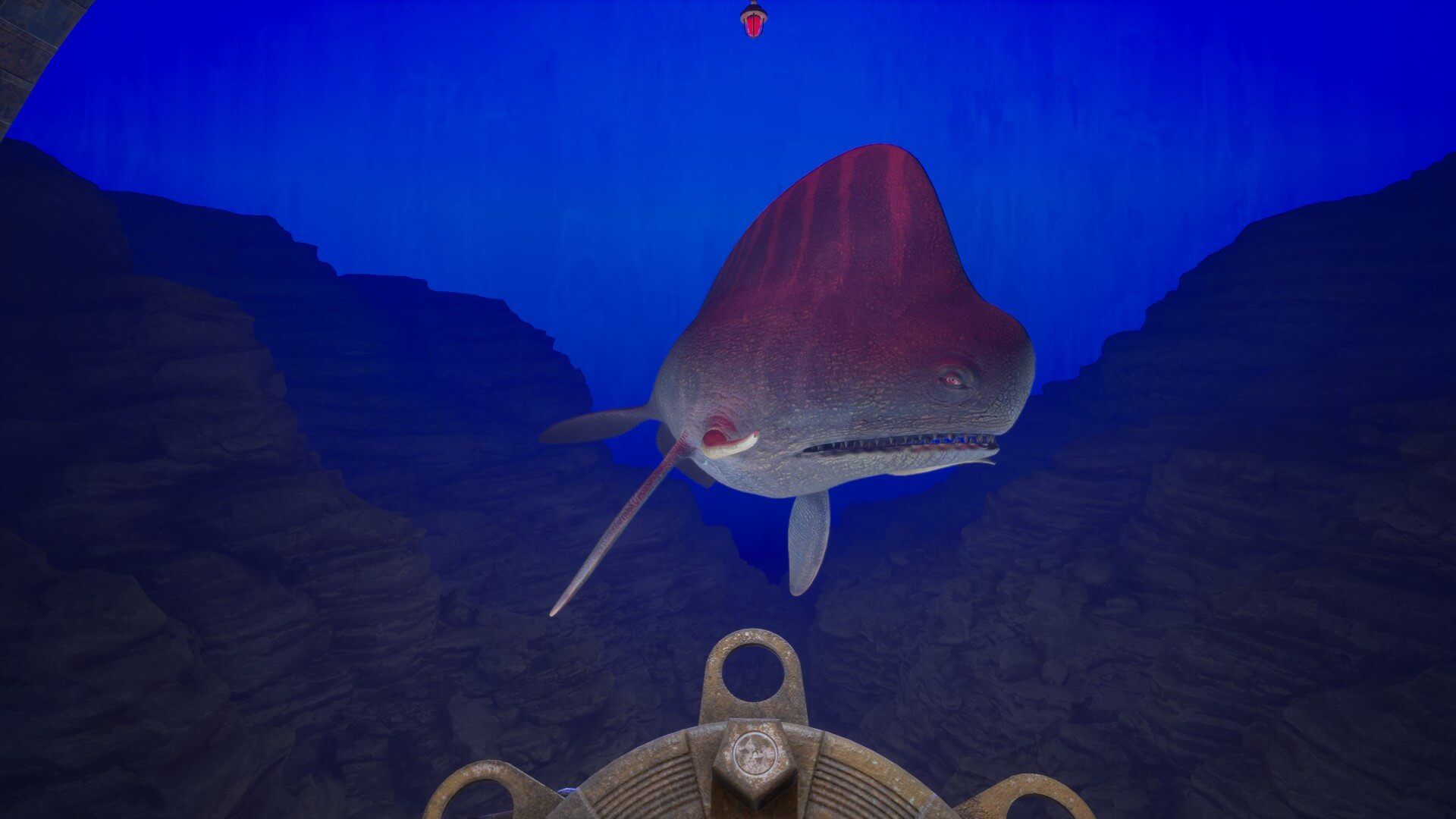 A large aquatic creature with a long maw is swimming near the players view. The lower section is coloured grey-white-ish, while the top has mainly red with a few lighter red stripes. 