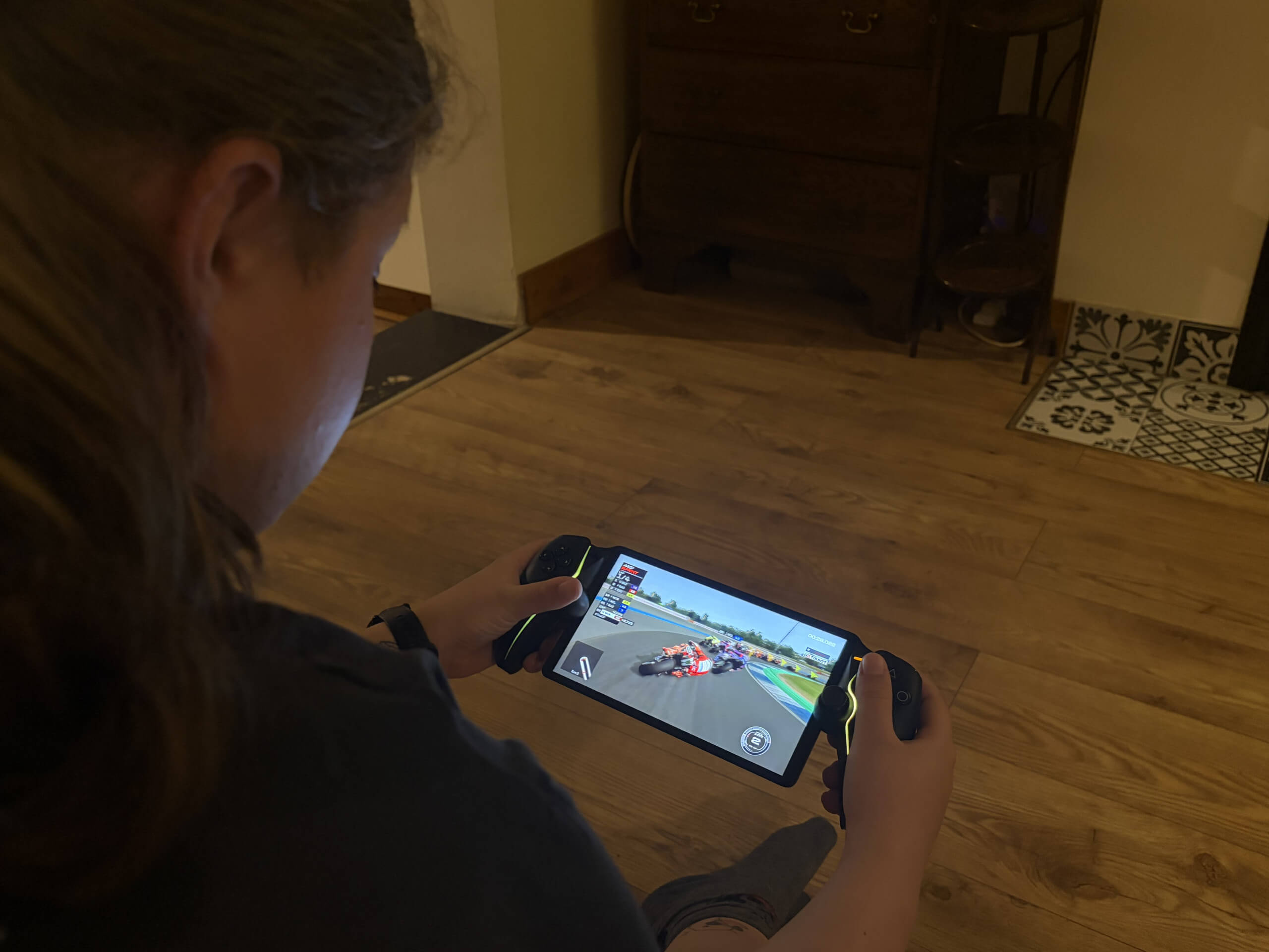 This image shows Olivia using the PS Portal to play MOTOGP.