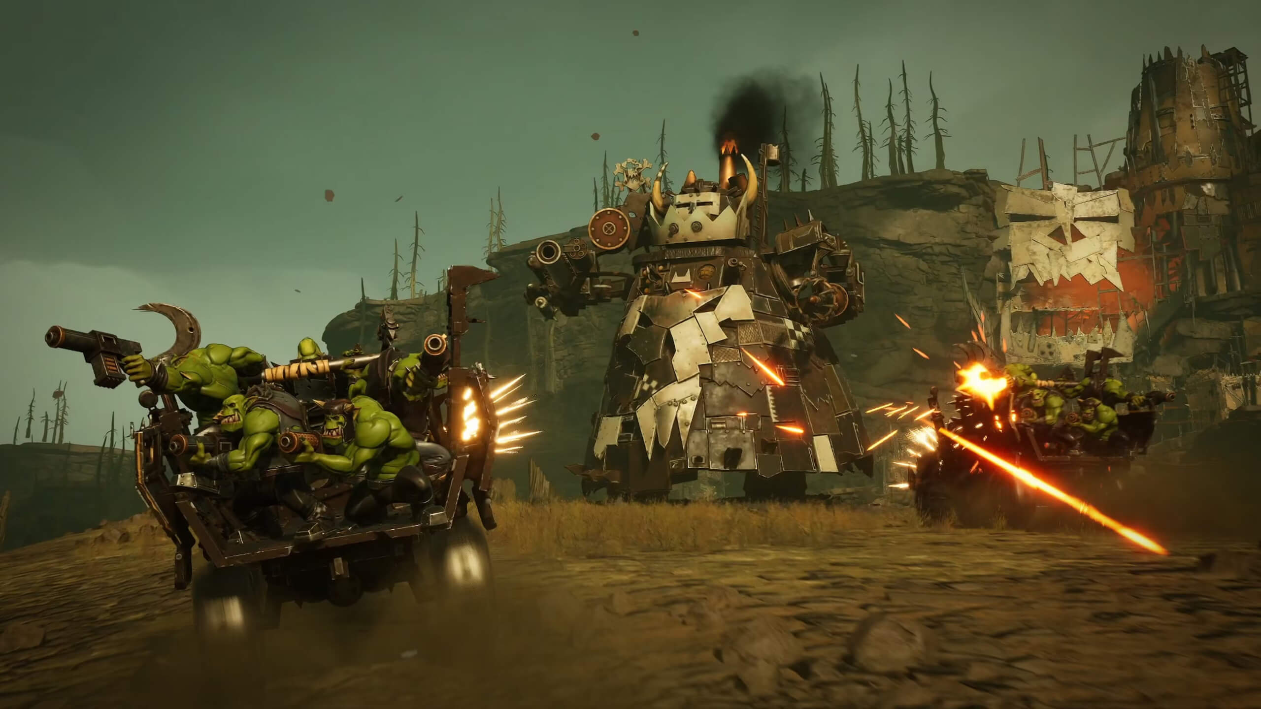 A "Stompa" is showing in the centre of the image. This is a large, bipedal mech built out of scrap. An enemy vehicle carrying a bomb is attempting to destroy it by driving straight into it.
