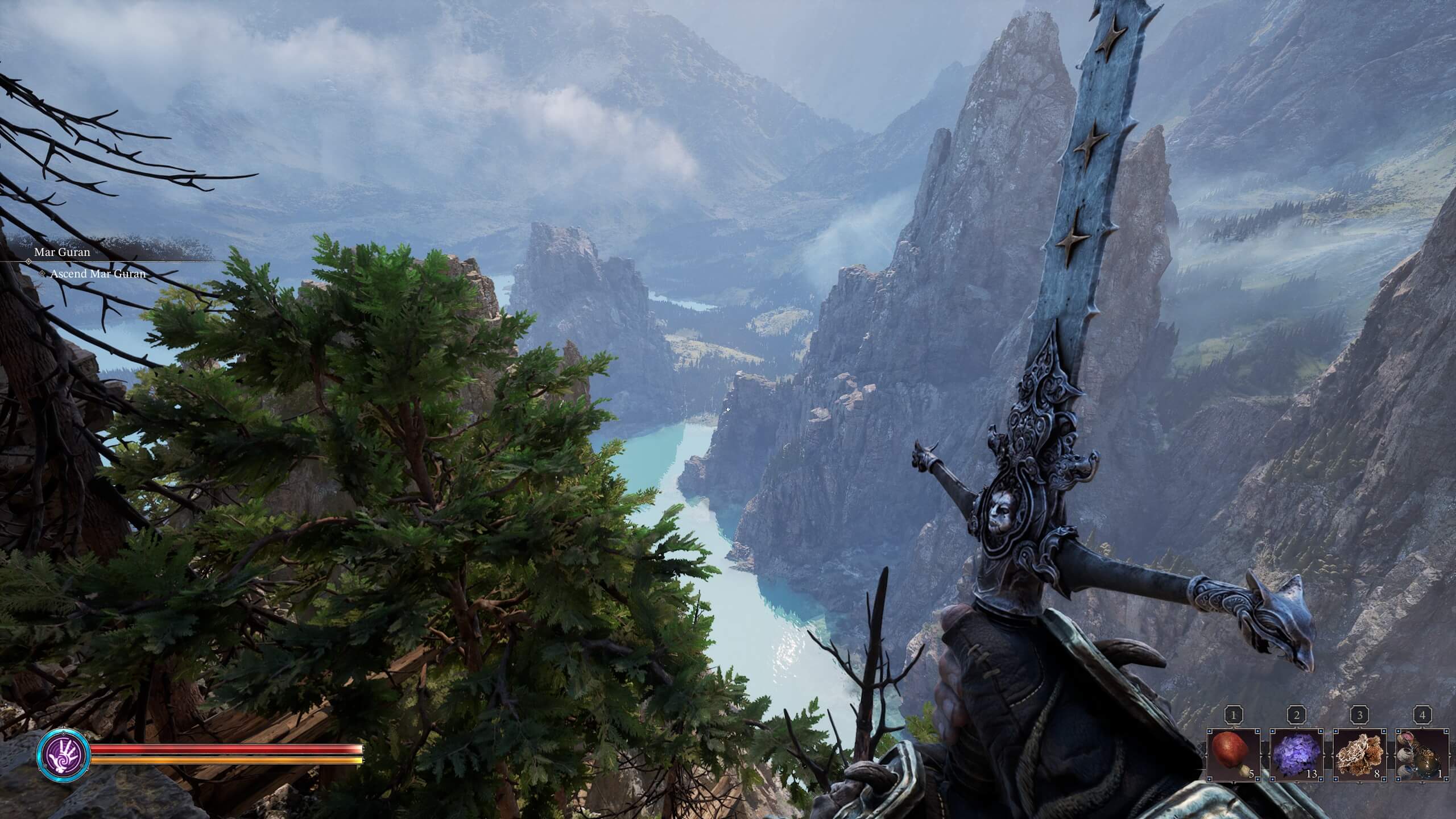 First-person view of a character holding an ornate sword overlooking a misty mountain valley with a winding river below.