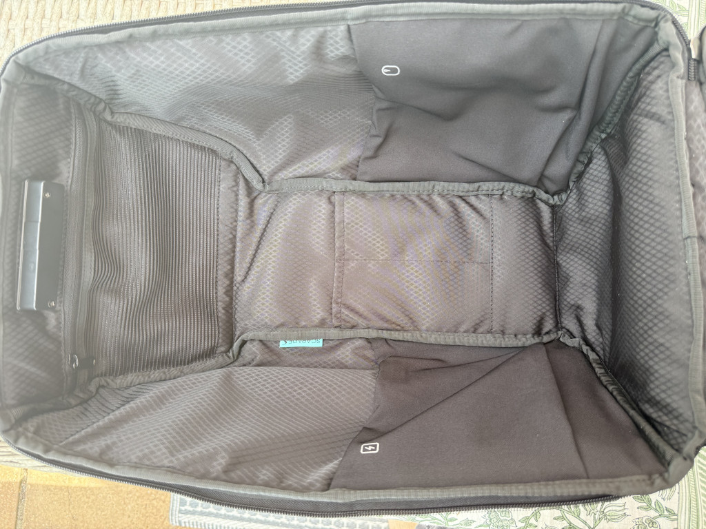 Photo of the inside of the black backpack revealing handy side pockets within.