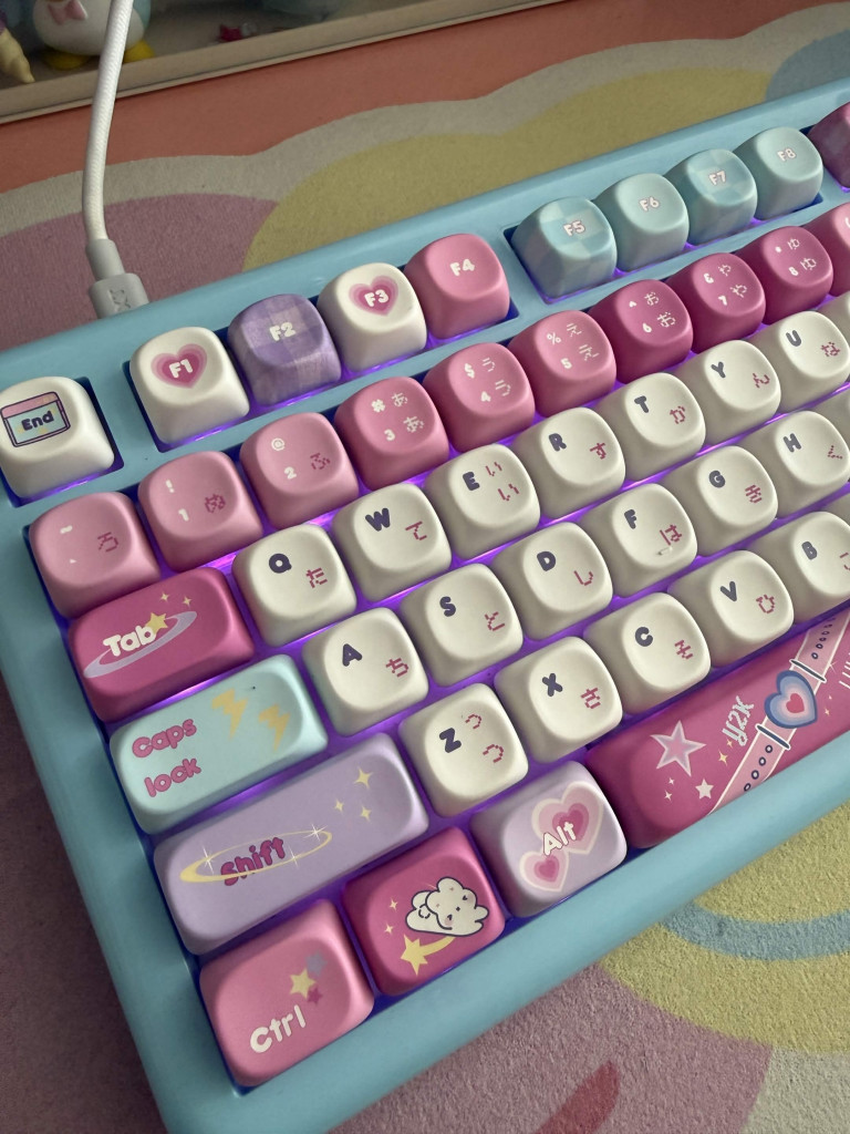 A KiiBOOM phantom 81 lite keyboard with the KiiBOOM X Elyxirine Digital Dreams: Pastel Y2K keycap set. Pastel blue coloured keyboard with pink, purple, and blue keys featuring cute heart, cloud, and star designs and Japanese characters in a Y2K theme.