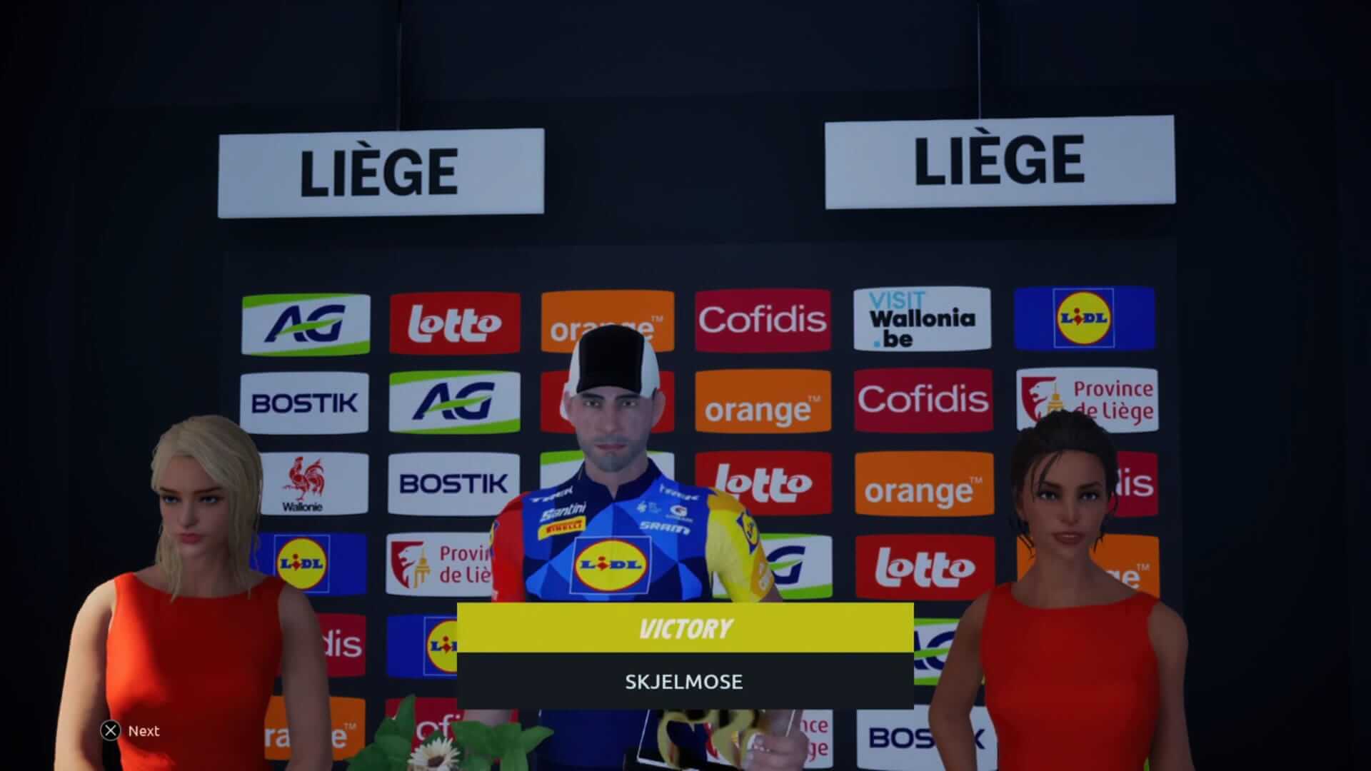 Cyclist celebrating victory at Liège with two women in red dresses, showcasing the event's branding and sponsor logos.