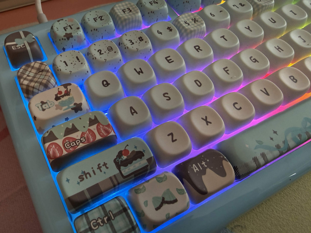 Close-up of blue kiiboom phantom 81 lite mechanical keyboard with pastel desert keycaps and rainbow backlighting.