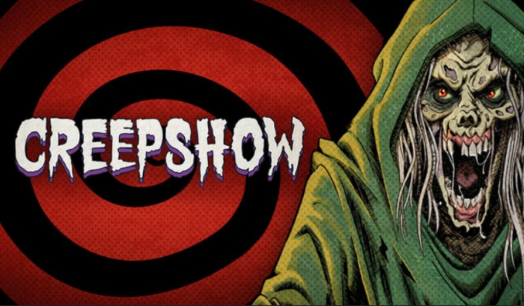 The background is a red and black spiral going inwards. A zombie like man with white tendril hair and a green hooded robe stands right, with flesh rotting off his face, and missing teeth. He's drawn in a comic book style. The text left of him says "Creepshow" in white.