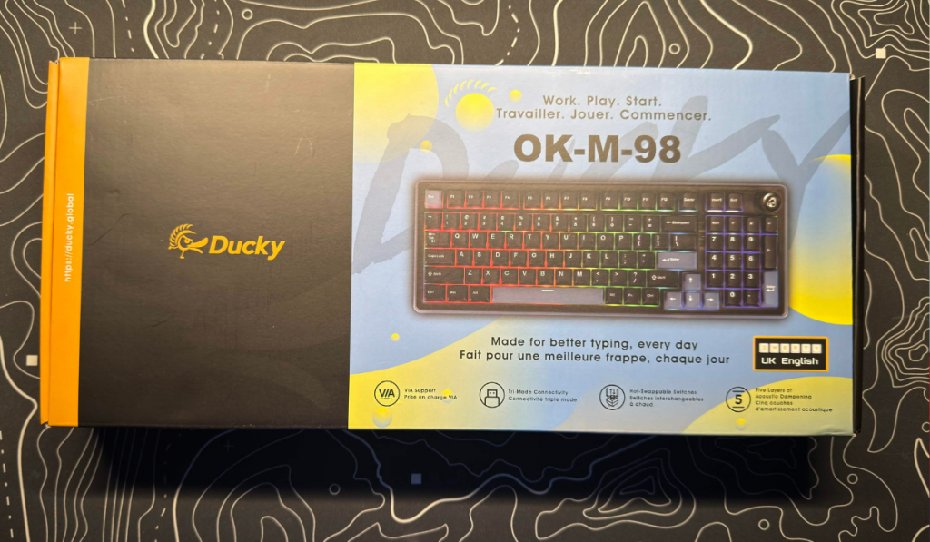 image of the ducky om m 98 keyboard in its box on a desk