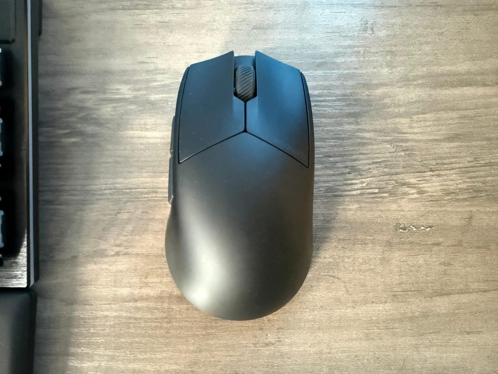 Close-up of a black bequiet Dark Perk Ergo mouse on a desk, highlighting its modern and ergonomic shape.